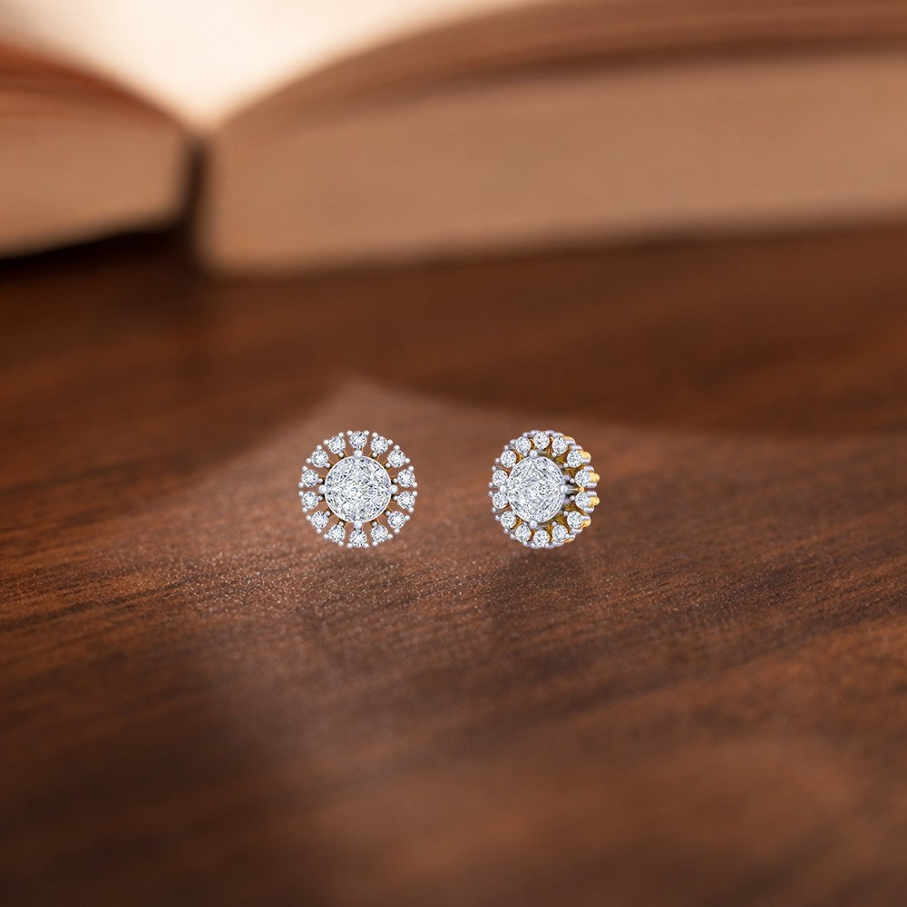 Gold and diamond halo women stud earrings with round center diamond and diamond halo on a white background.