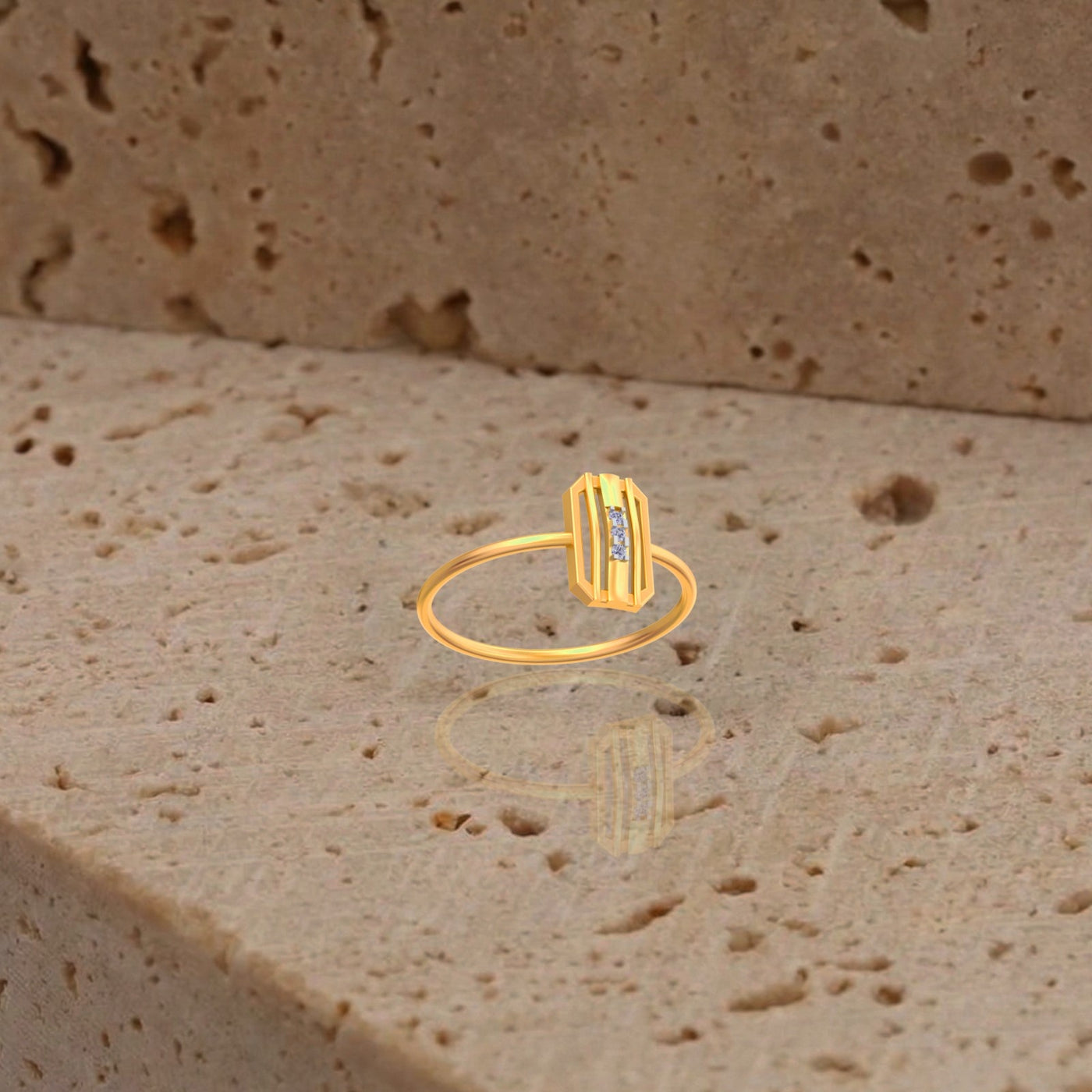 Gold ring with a diamond on a textured beige surface