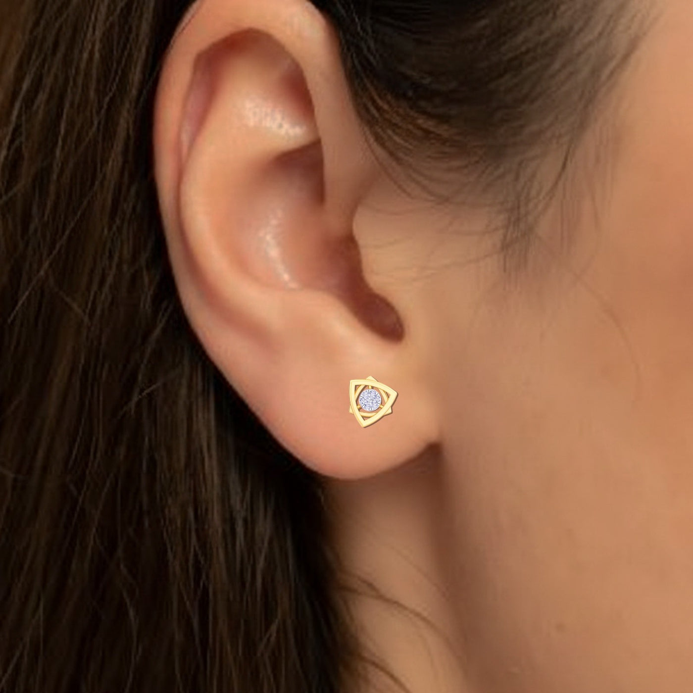 Close-up shot Yellow gold and diamond stud earring.