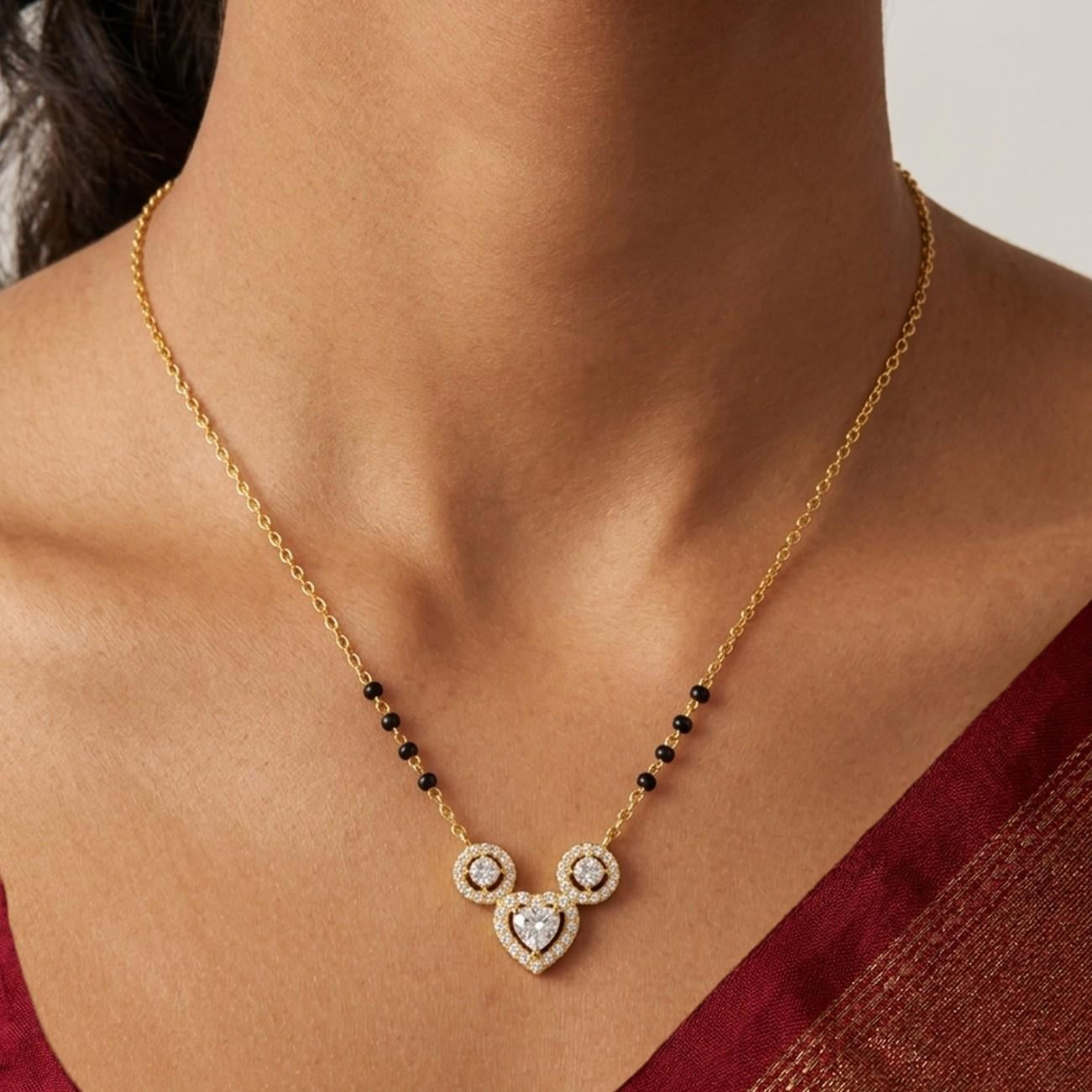 Women wearing gold & diamond heart mangalsutra