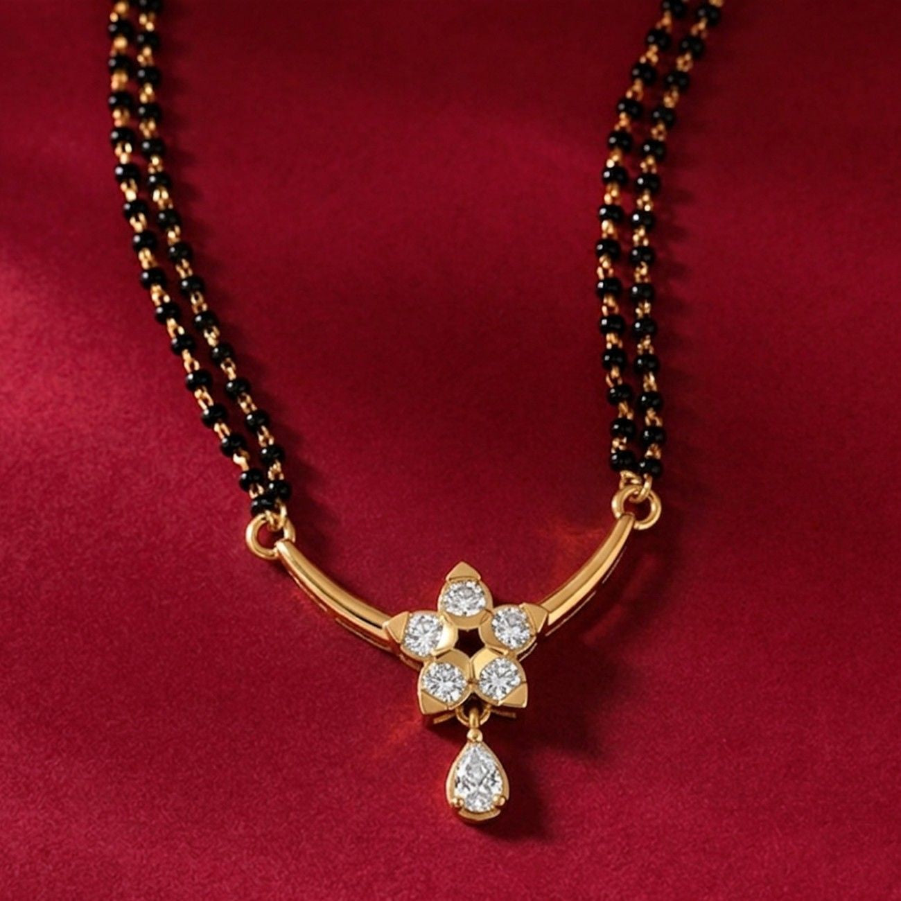 Yellow gold & diamond floral beaded mangalsutra on red background