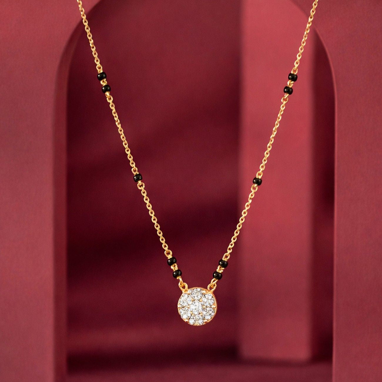 Yellow Gold & Diamond Round Mangalsutra on red background
