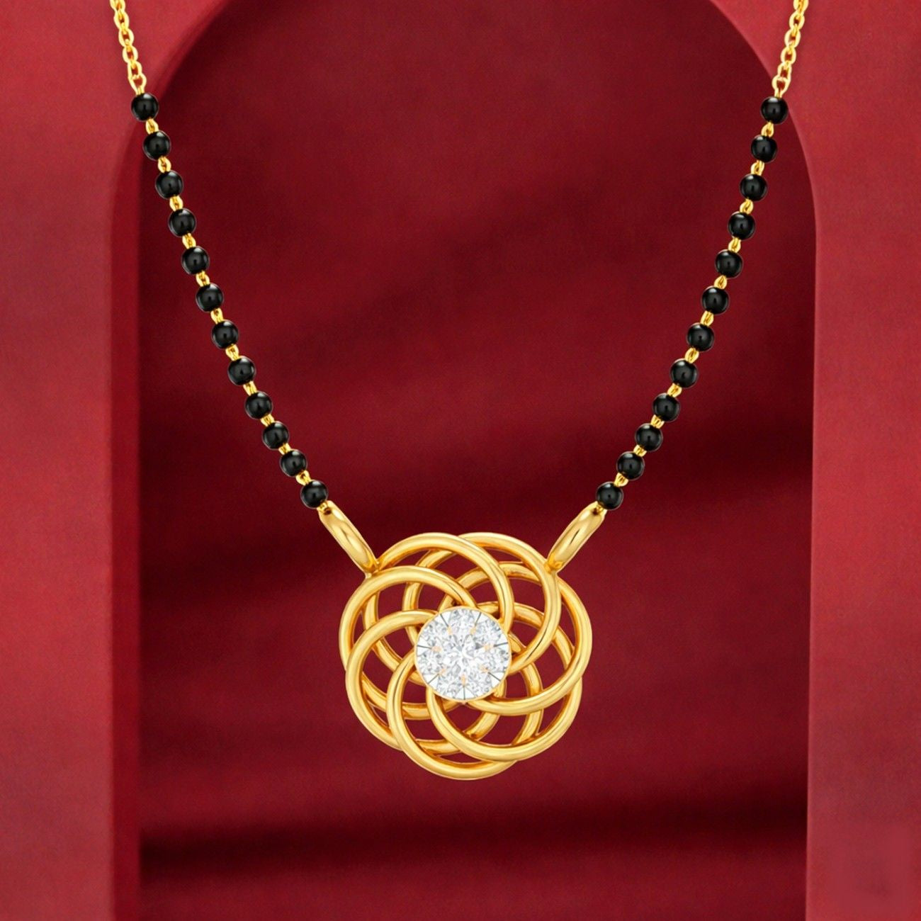 Yellow gold & diamond modern mangalsutra on red background
