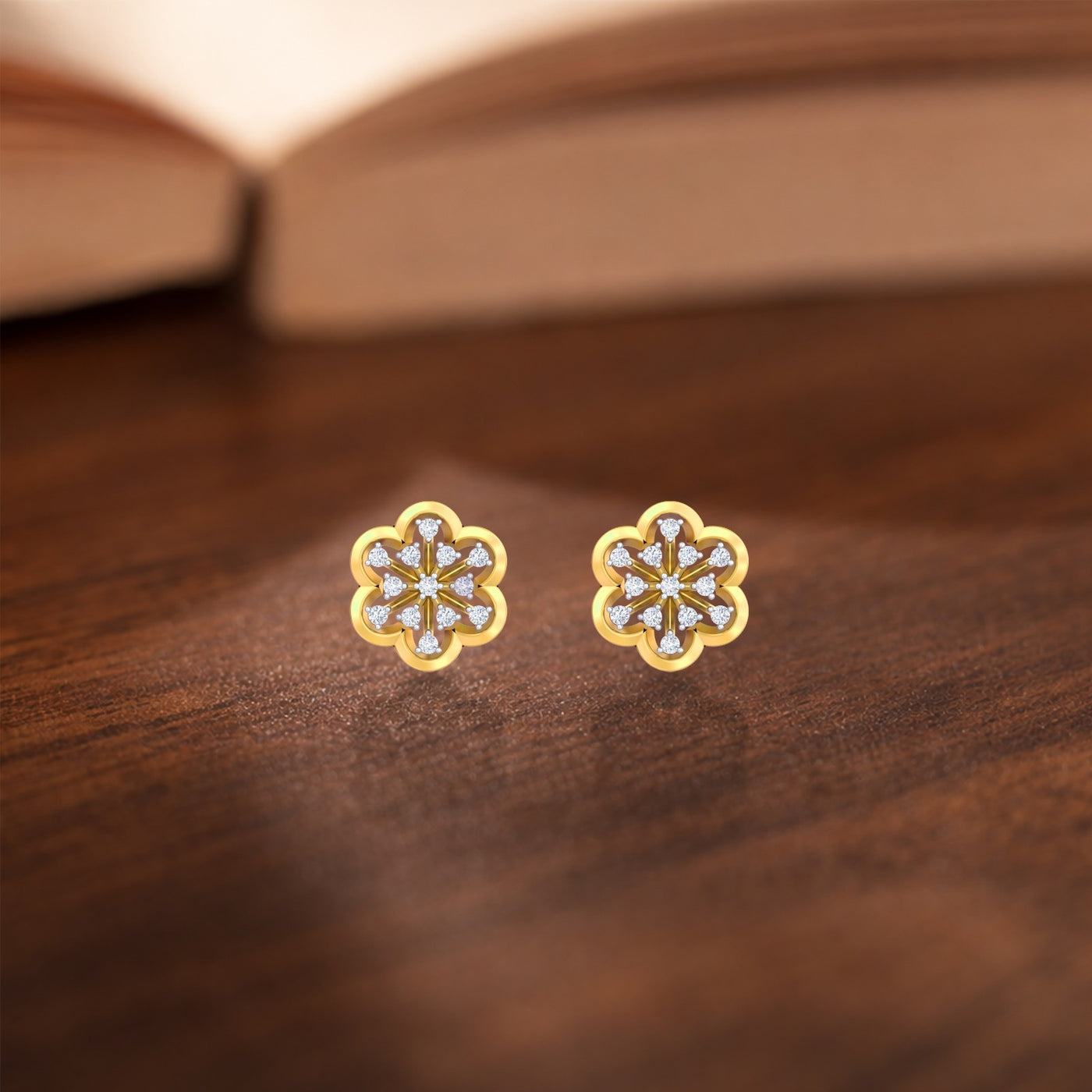 Gold and diamond stud earring with floral-design on a wooden surface.
