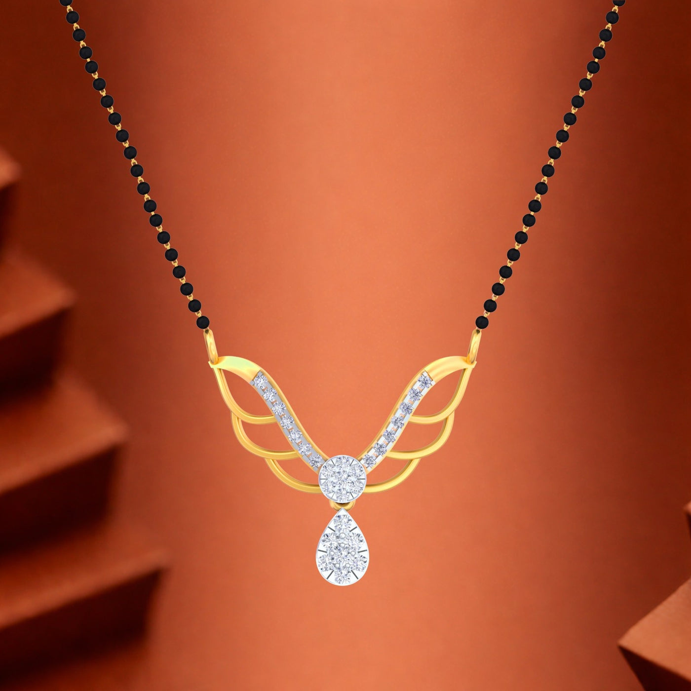 Gold mangalsutra with diamond on an orange background