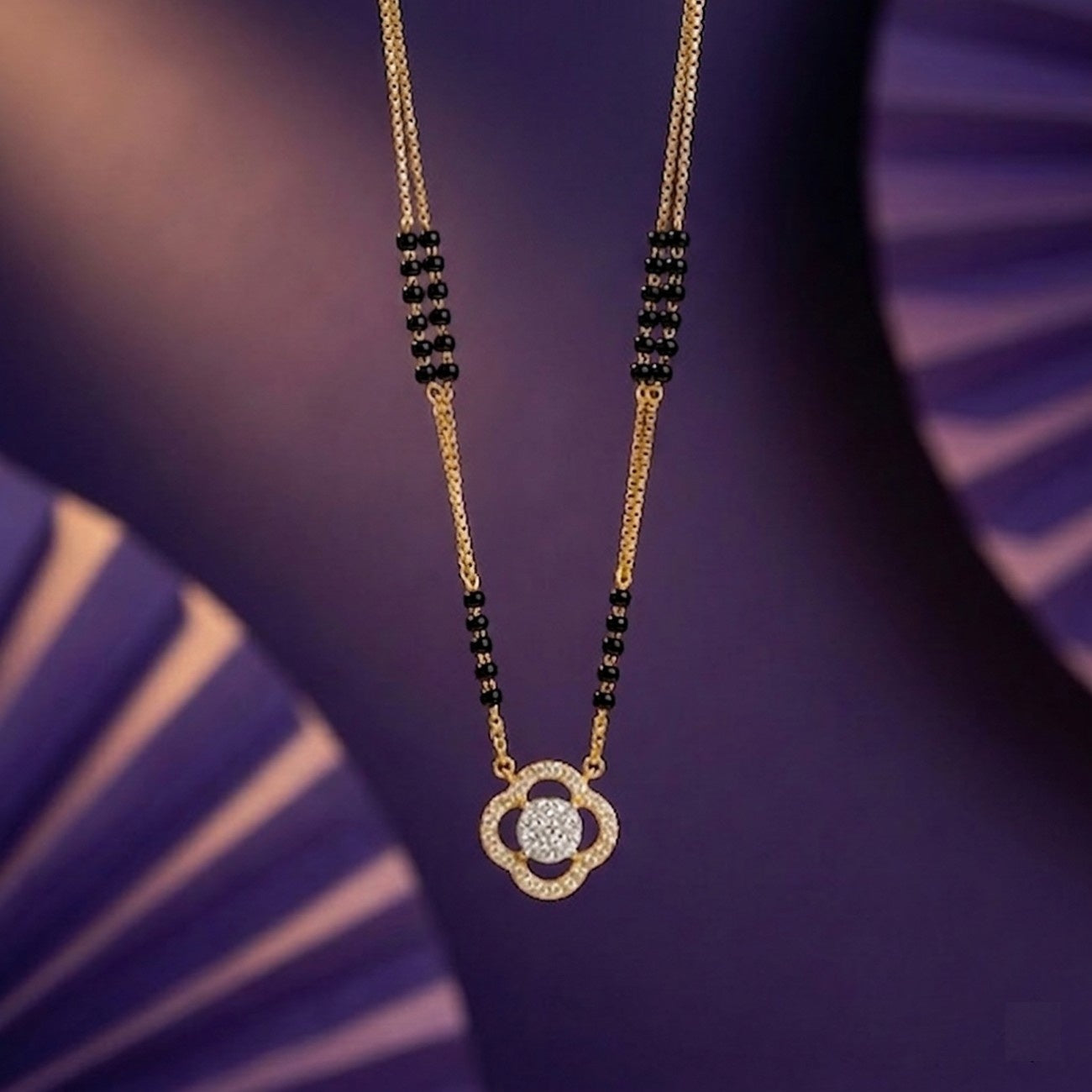 gold & diamond floral beaded mangalsutra on purple background