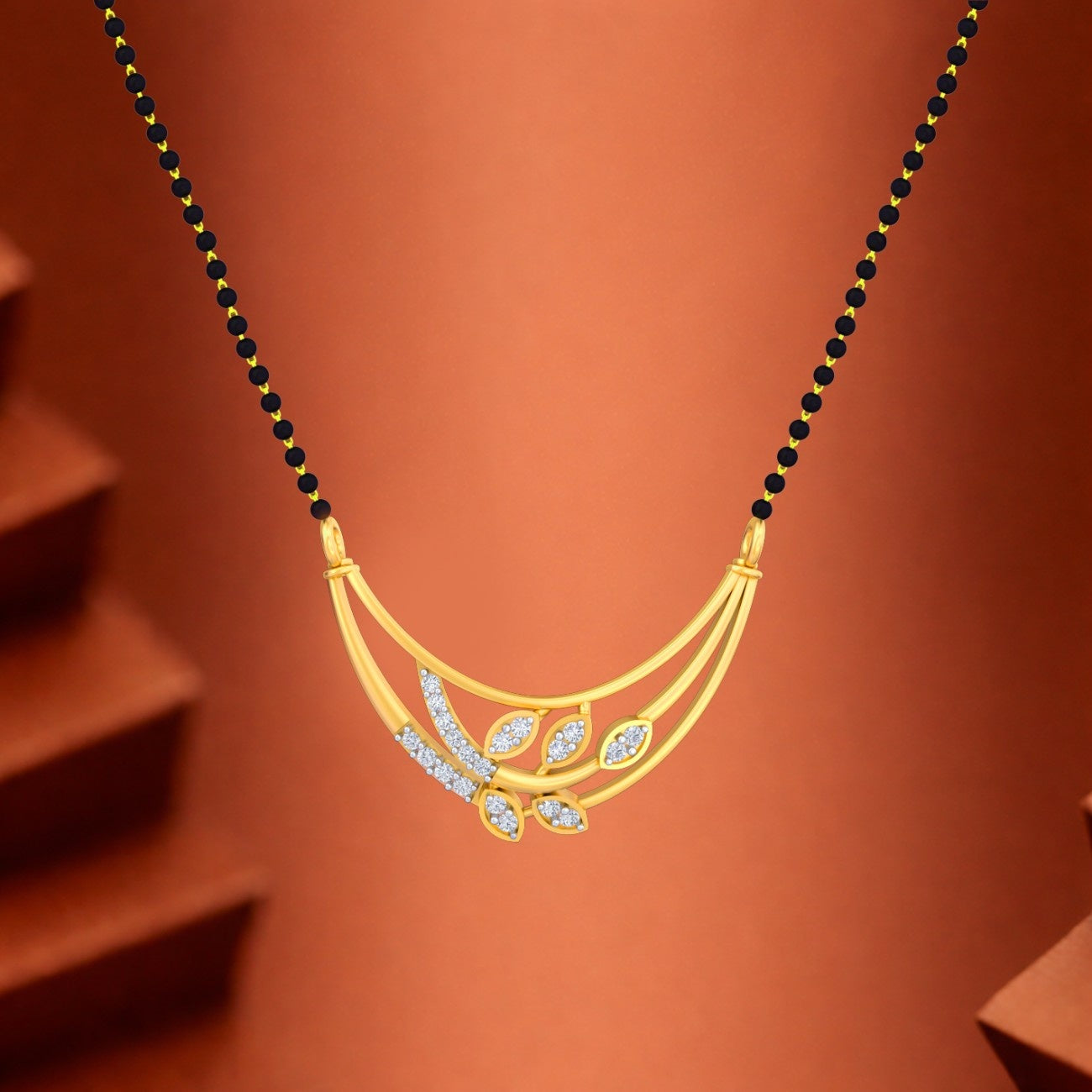 Yellow gold & diamond floral mangalsutra on brown background