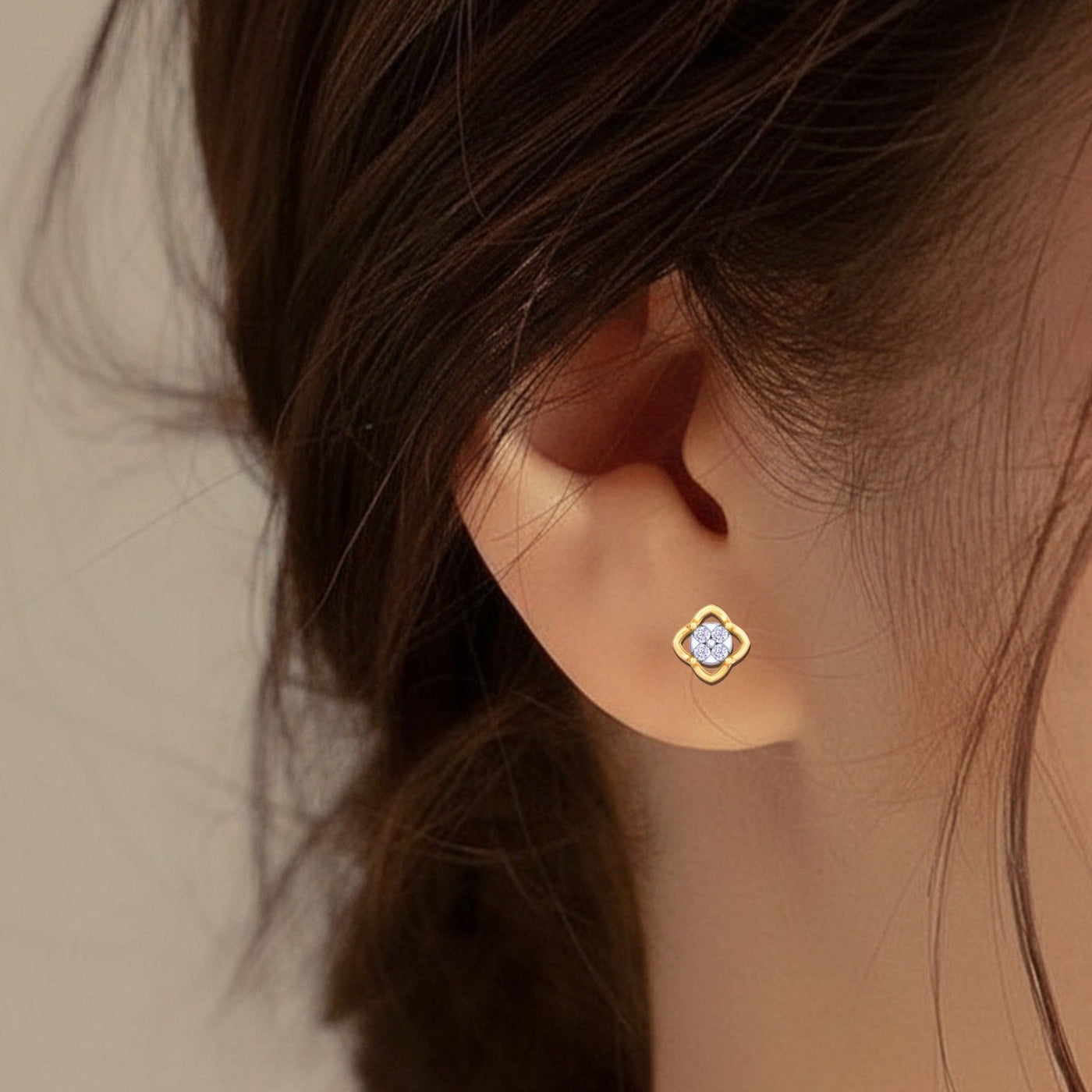 Close-up shop gold and diamond floral stud earrings 