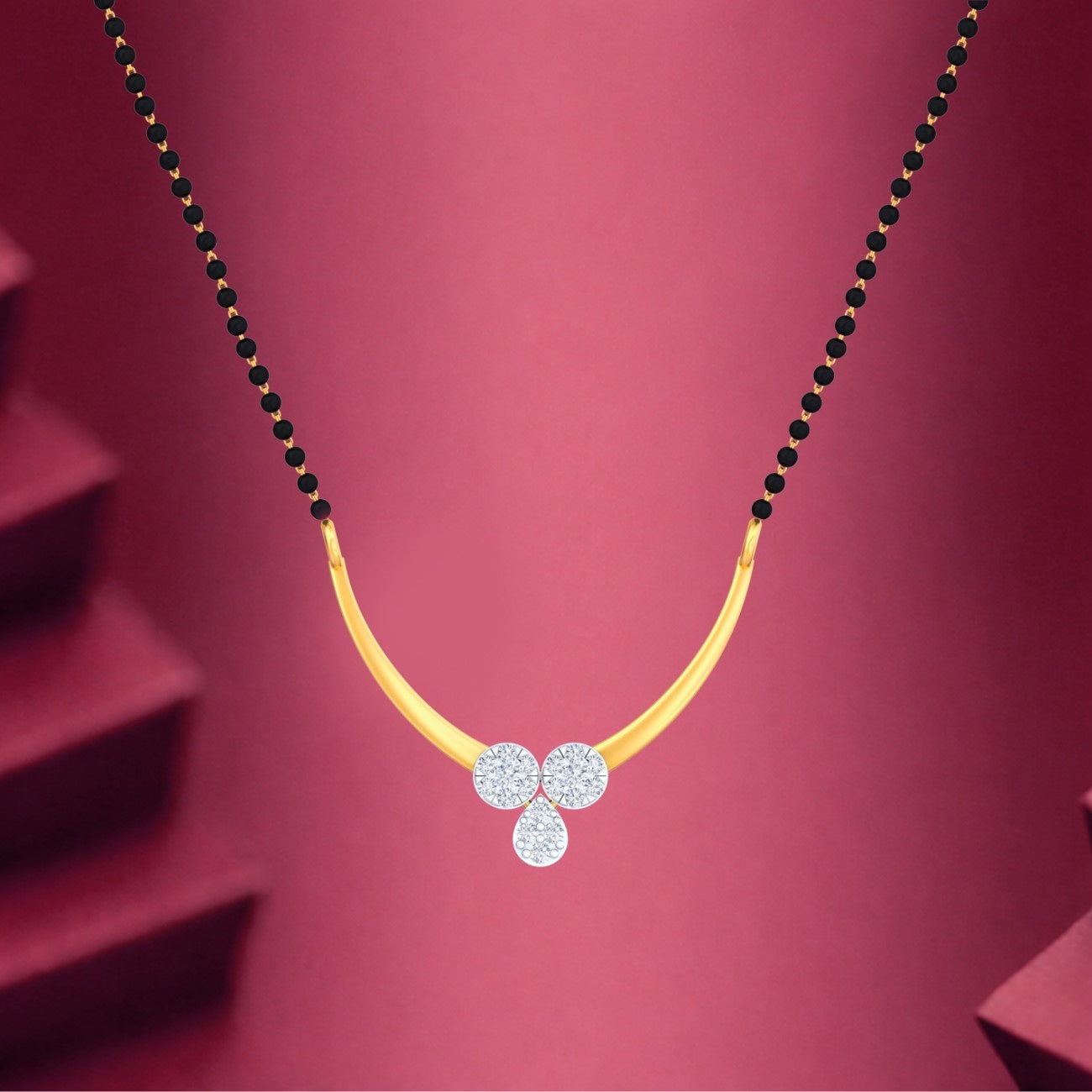 Yellow gold & diamond modern floral mangalsutra on maroon background