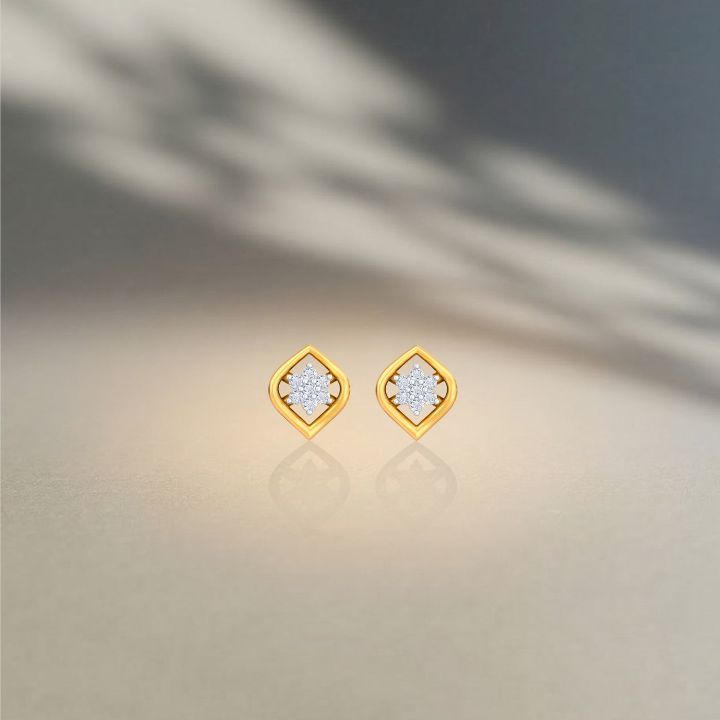Gold and diamond stud earring on a neutral background