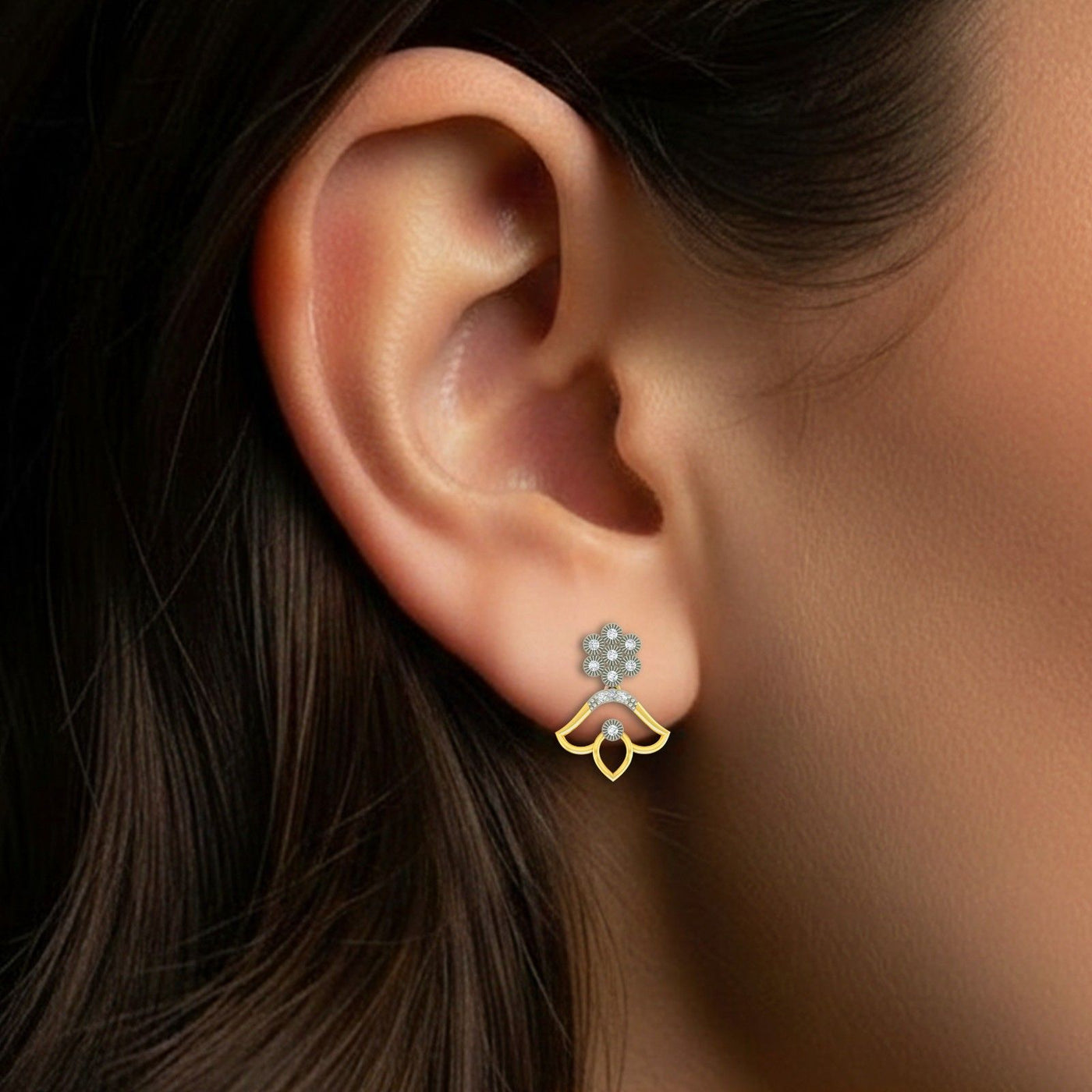 Close-up of an ear wearing a floral drop earring.