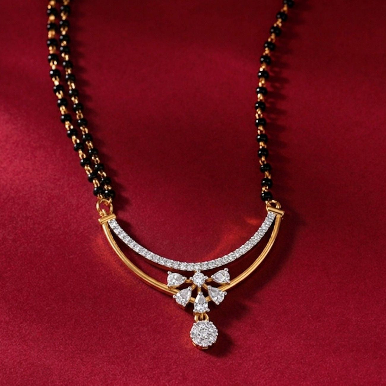 Yellow gold & diamond bridal mangalsutra on red background