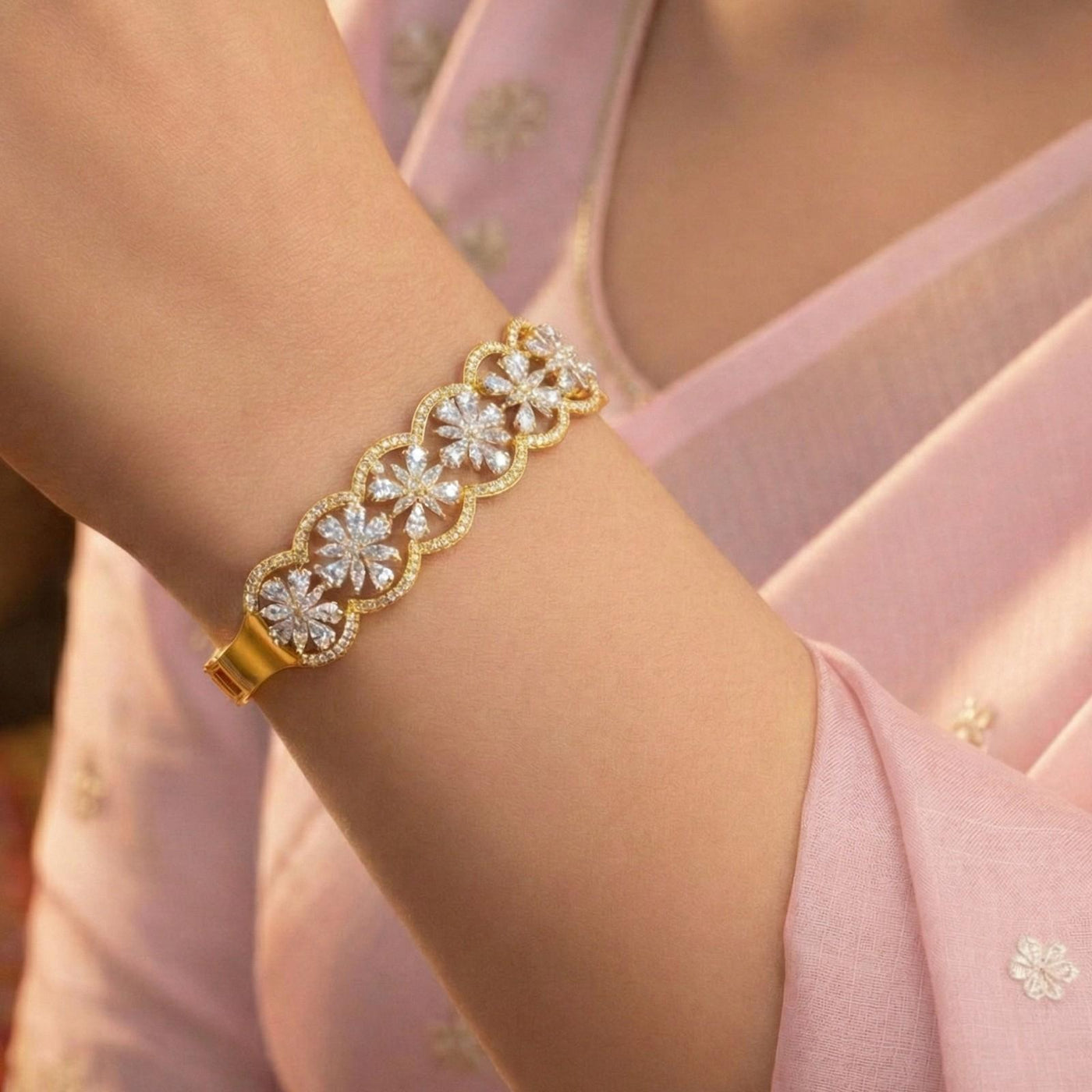 Gold bangle bracelet with open scallop frames enclosing marquise diamond floral clusters.