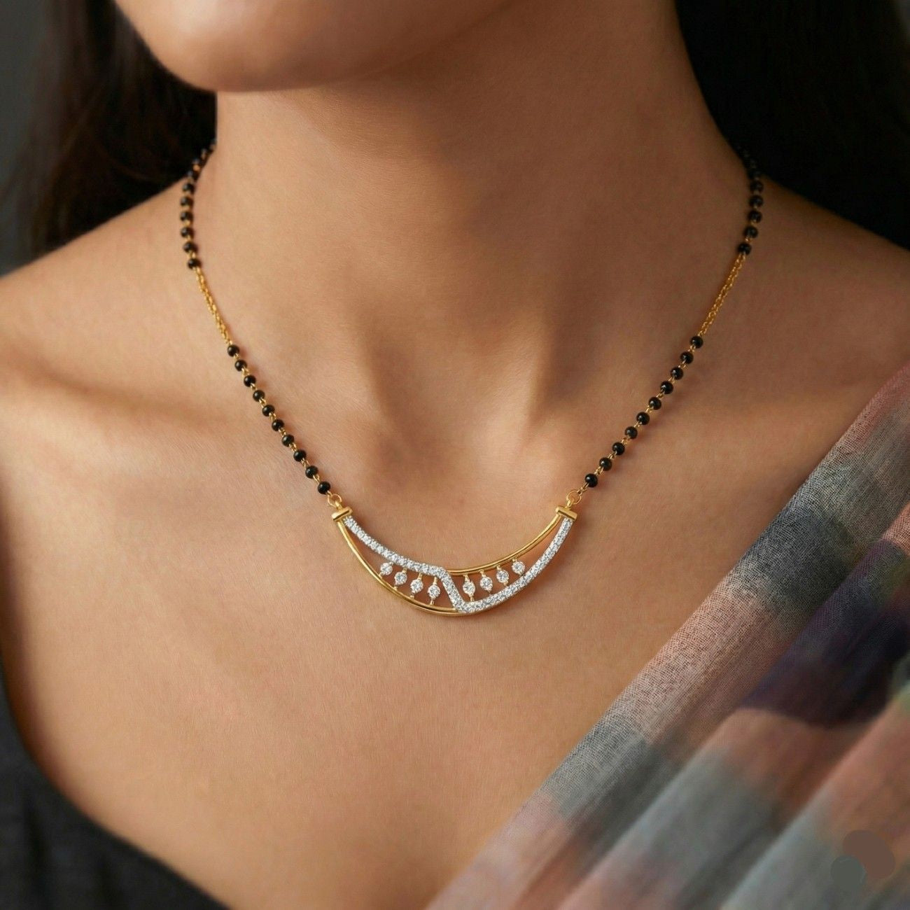 Women wearing gold & diamond modern mangalsutra 
