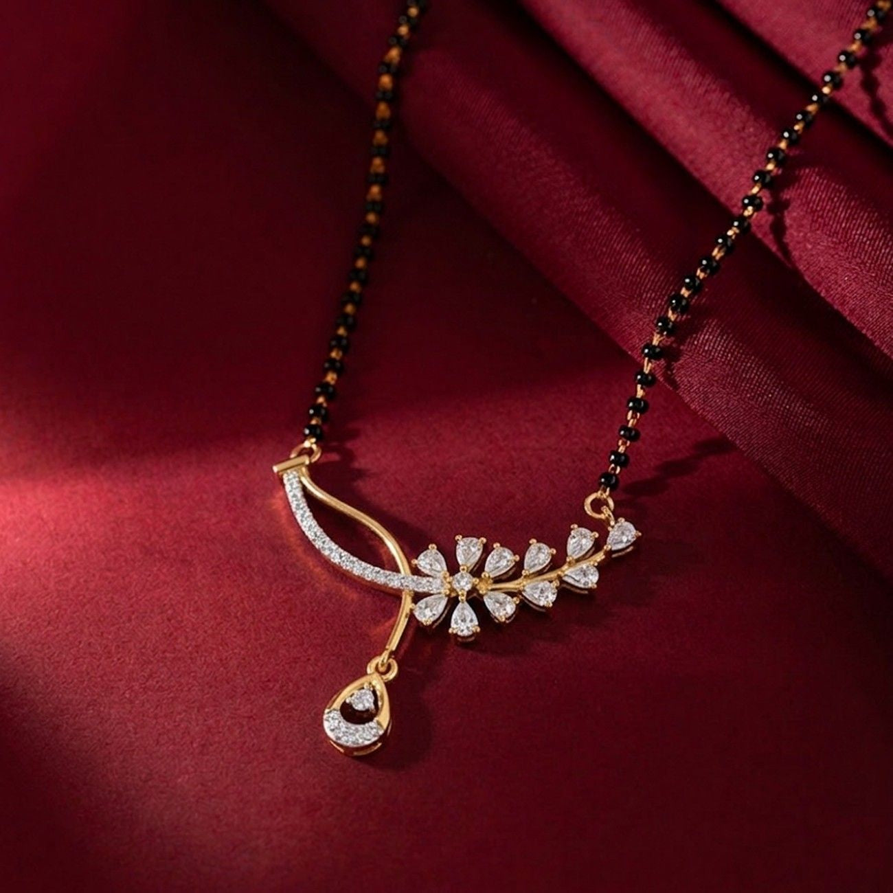Yellow gold & diamond floral mangalsutra on red background
