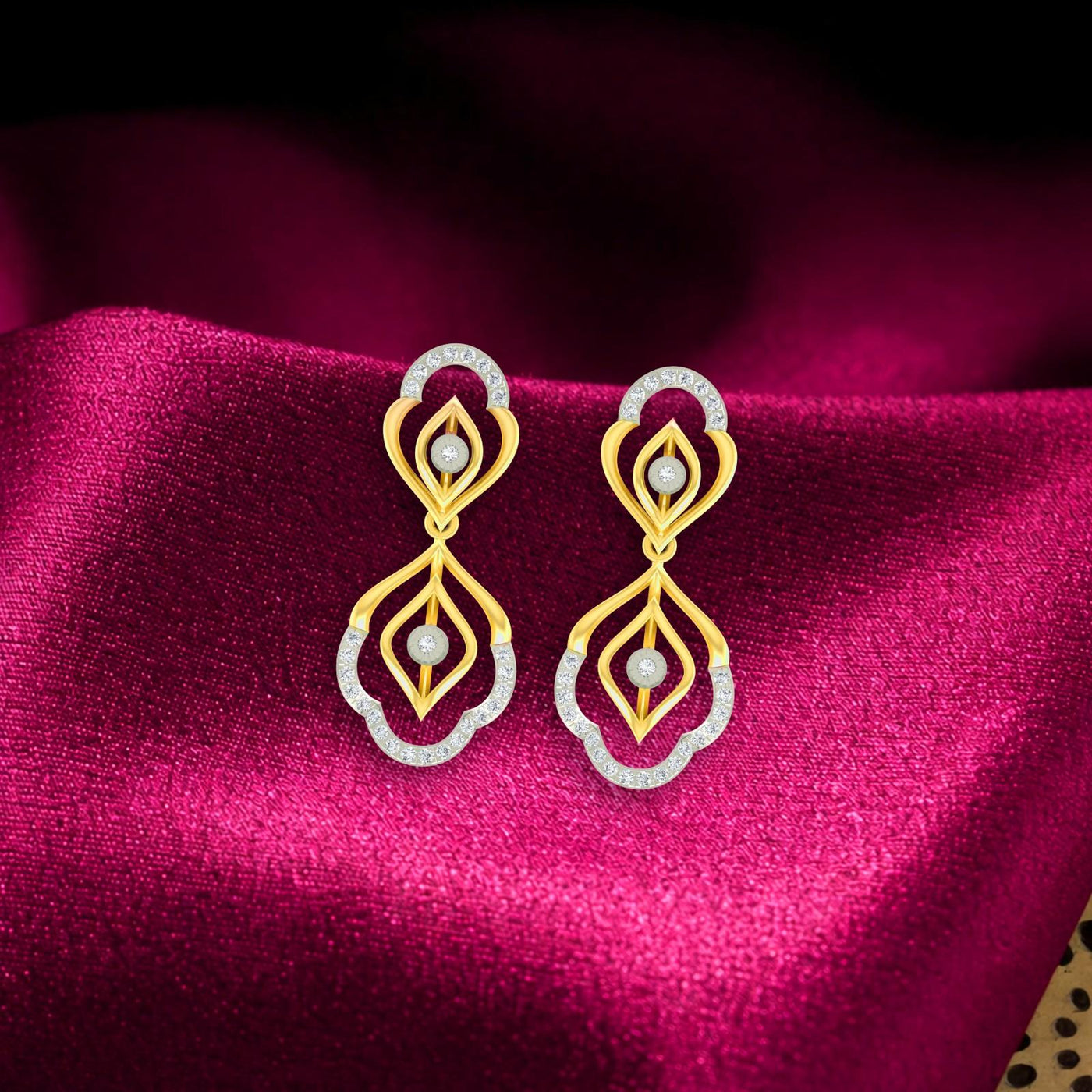 Gold and diamond drop earring on a pink surface.