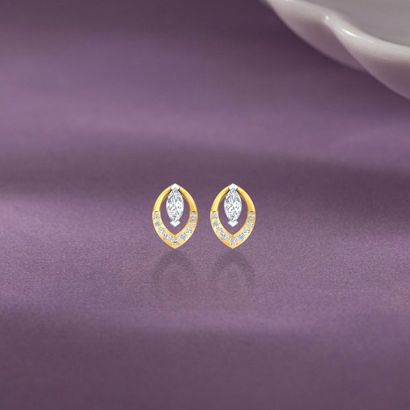 Pair of gold and diamond stud earrings on a purple background.