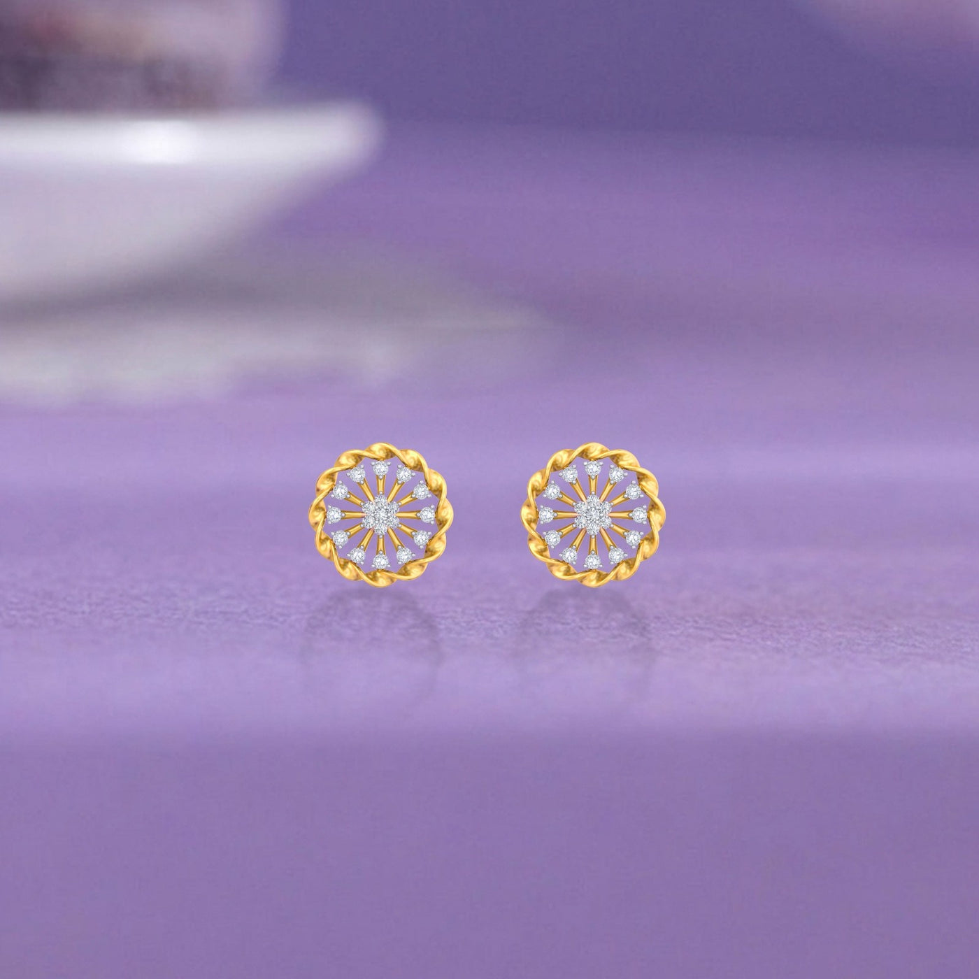 Gold and diamond stud earring with round-shaped on a purple background.
