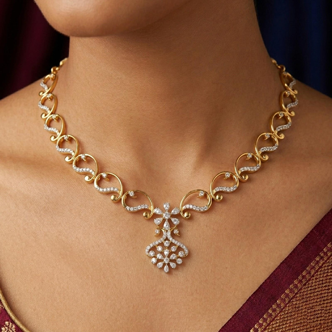 A close-up of a woman's wearing a gold and diamond necklace.