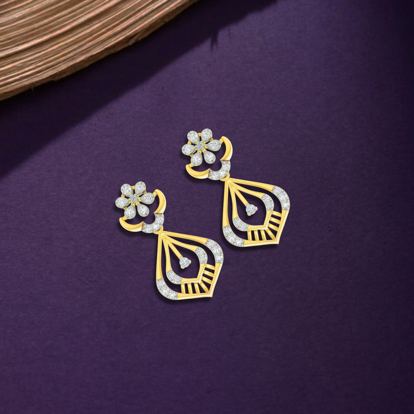 Gold and diamond earrings with diamond accents on a purple background.