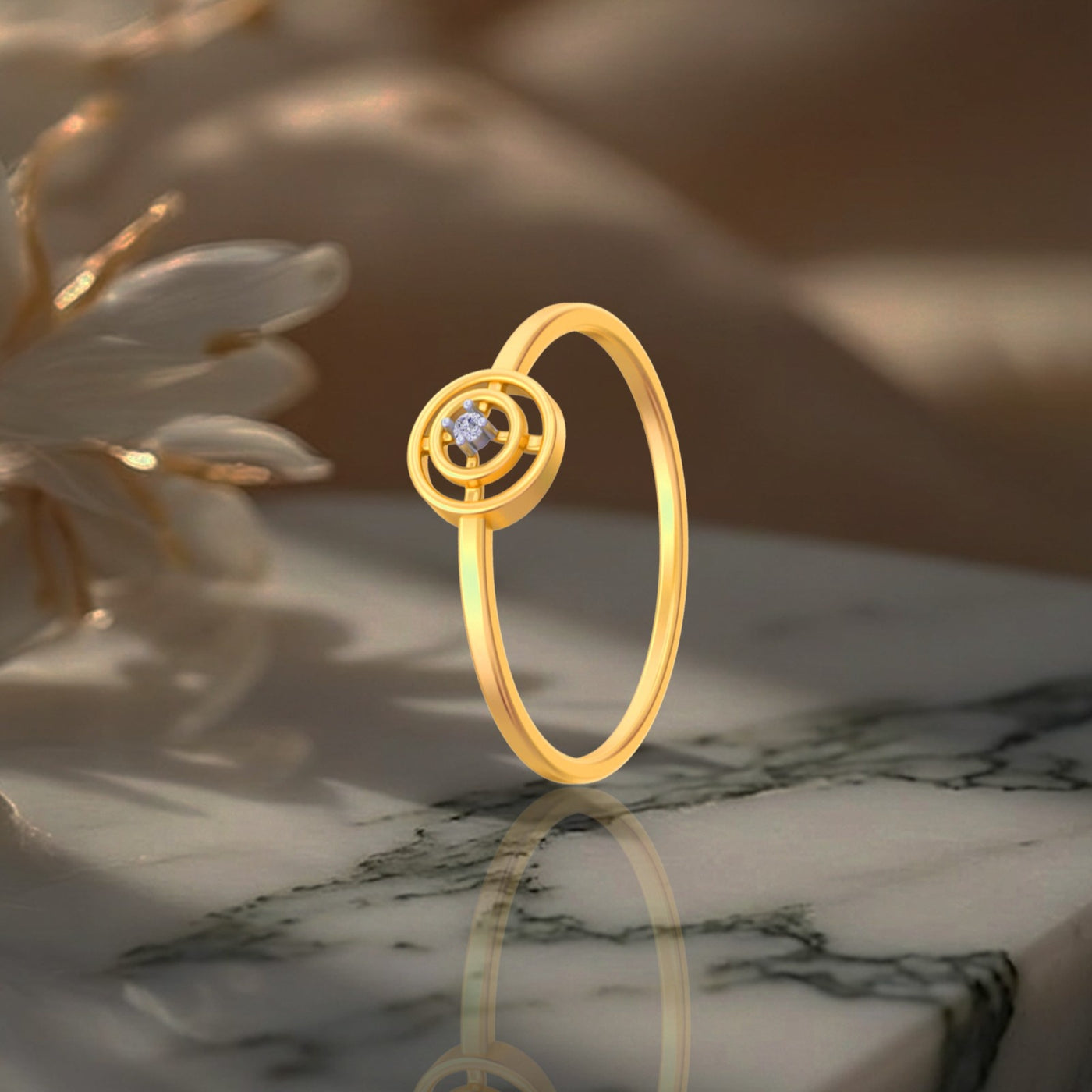 Gold ring with a central gemstone on a marble surface with flowers in the background