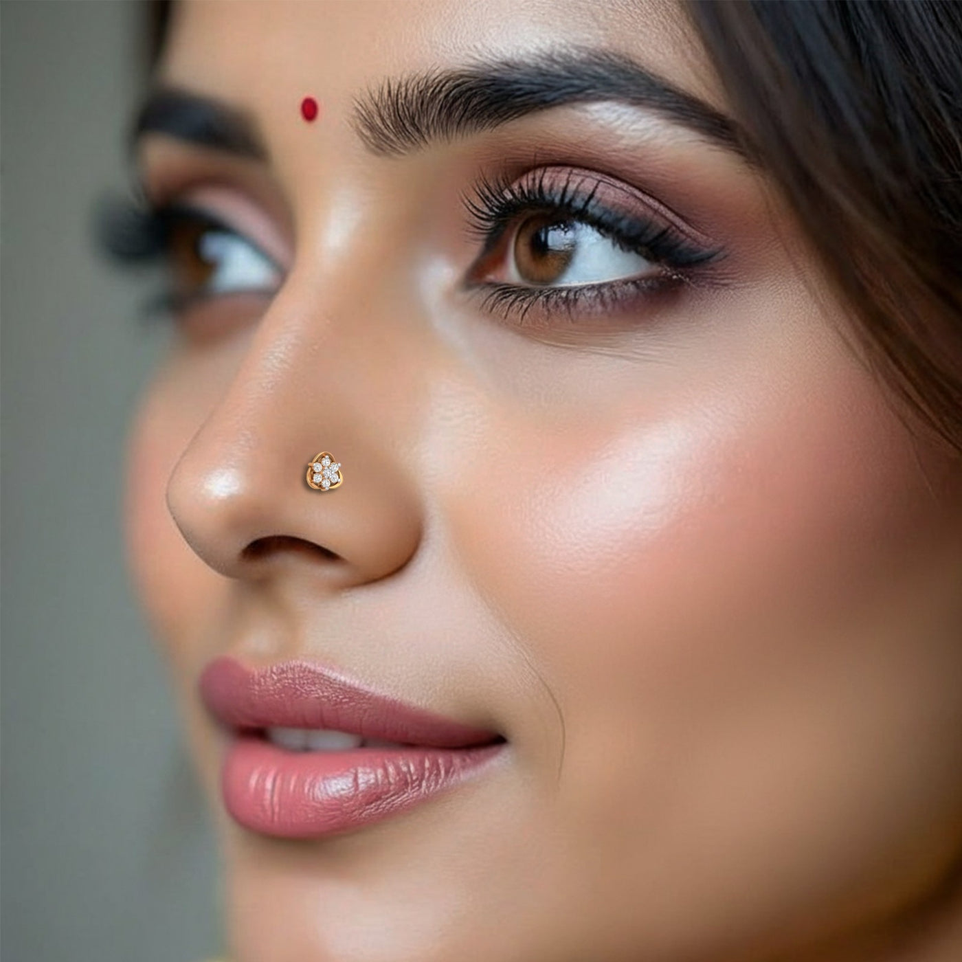 Close-up of a woman's face with a focus on her nose pin and lips.