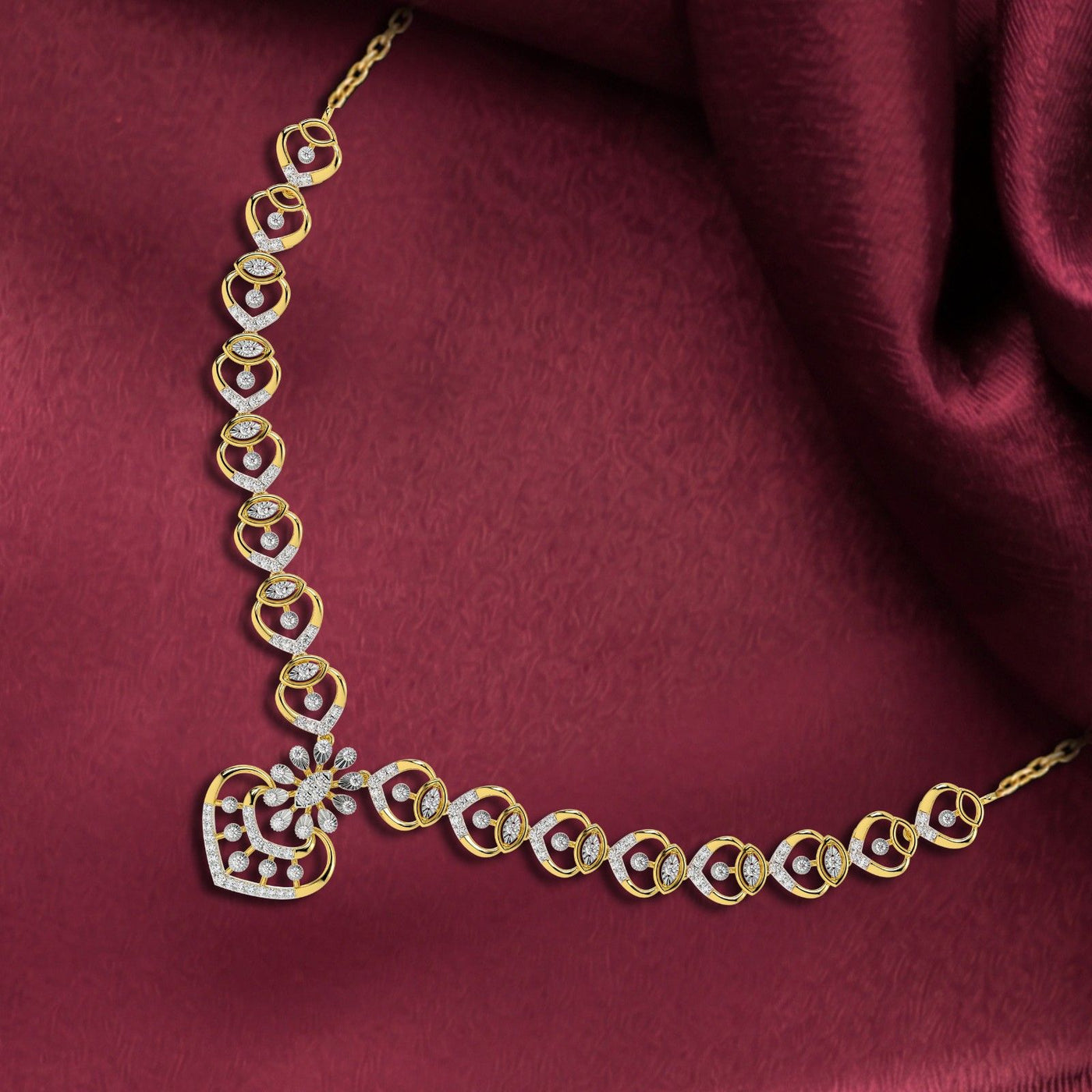 Gold and diamond necklace set, displayed on a draped dark red satin fabric.