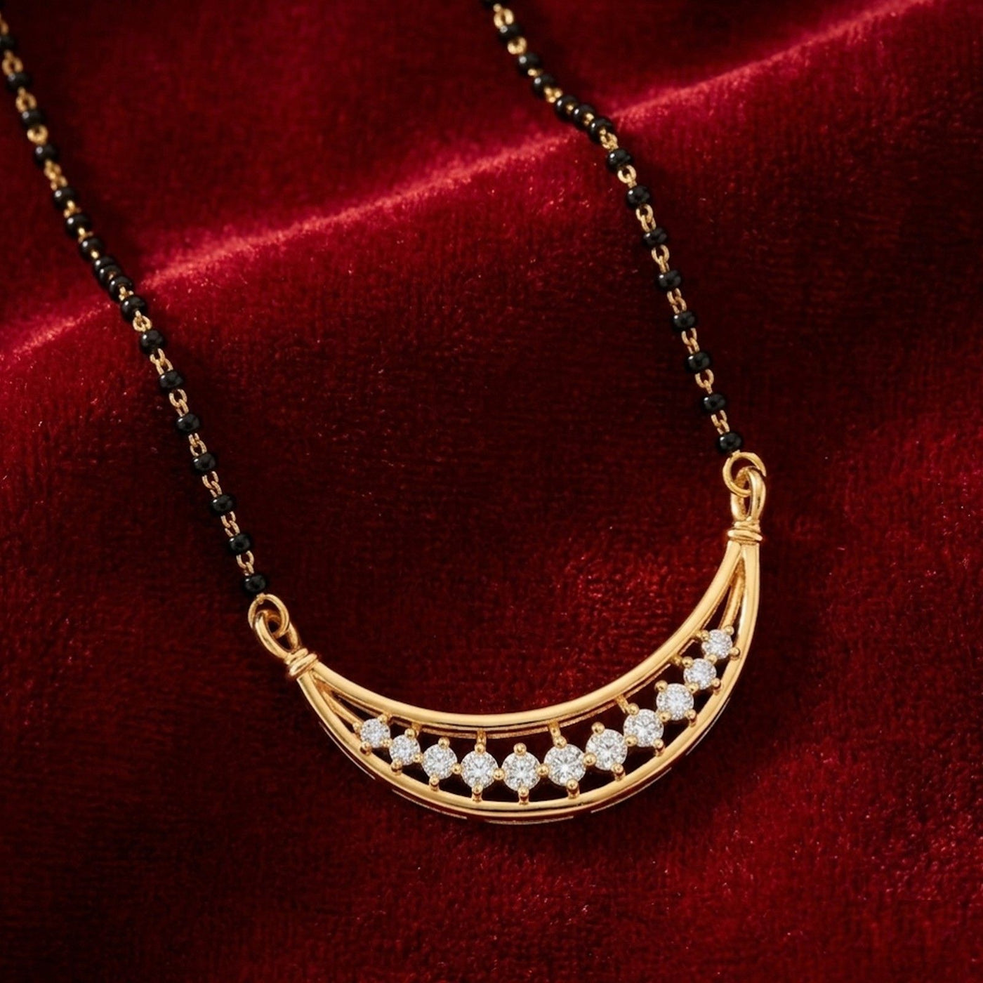 Gold mangalsutra with diamond on a red velvet background