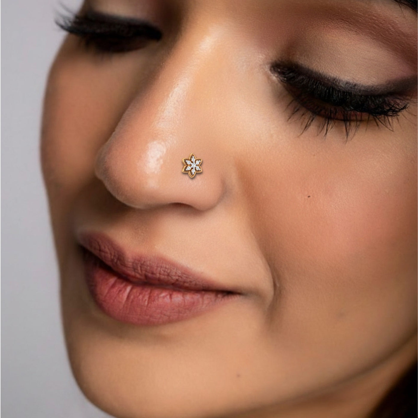 Close-up of a person wearing a nose pin with a small decorative piece.