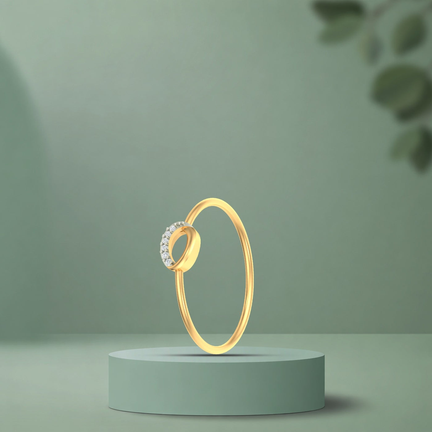 Gold ring with a diamond on a green pedestal against a green background