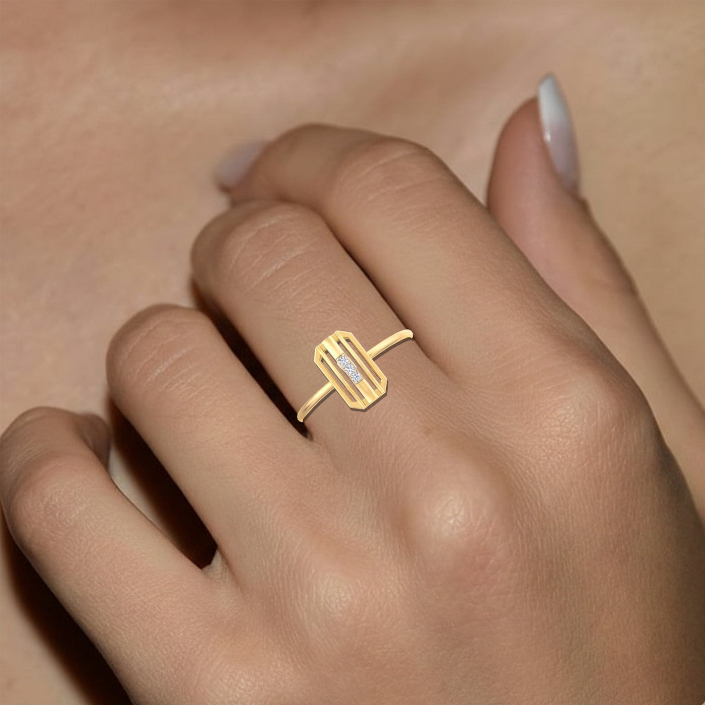 Gold ring with a diamond on a person's finger against a neutral background