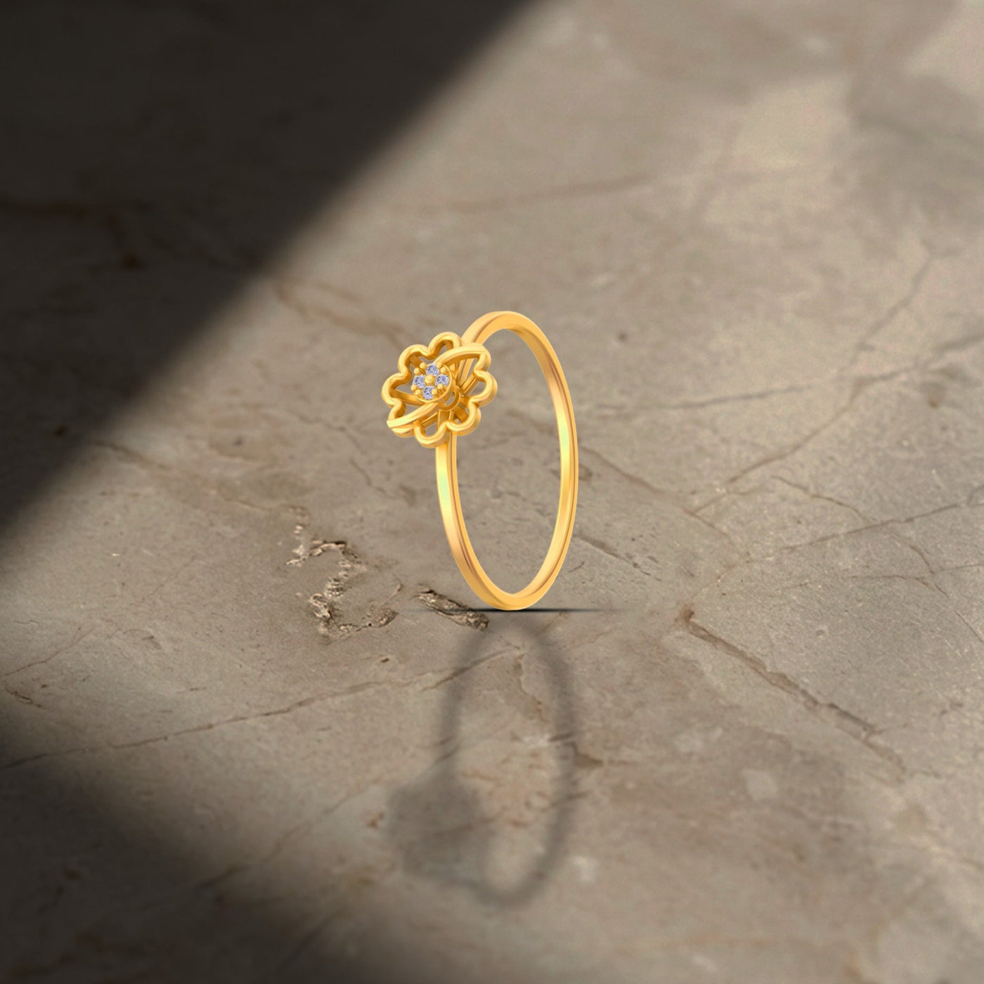 Gold ring with a floral design on a textured surface