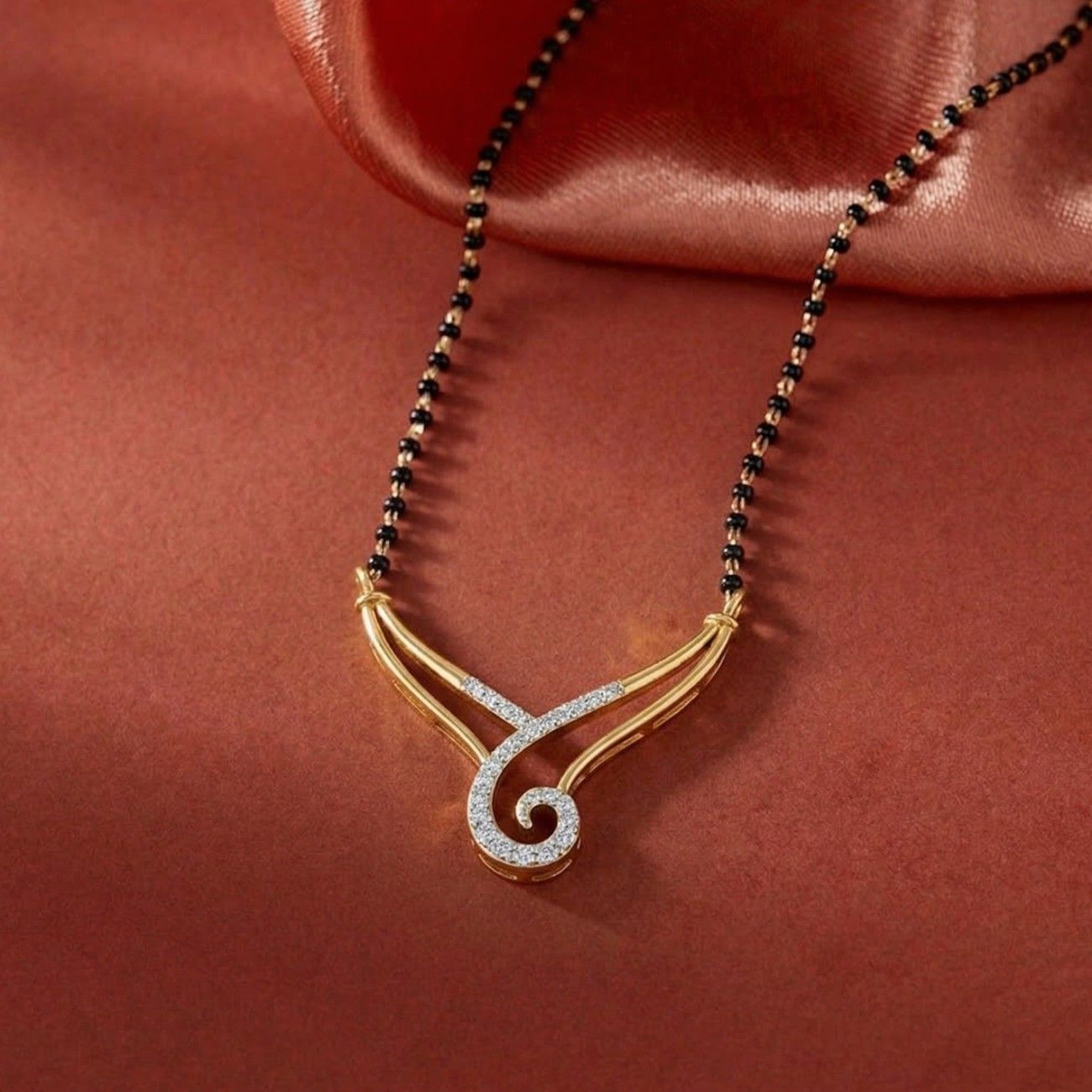 Yellow gold & diamond modern mangalsutra in red background 
