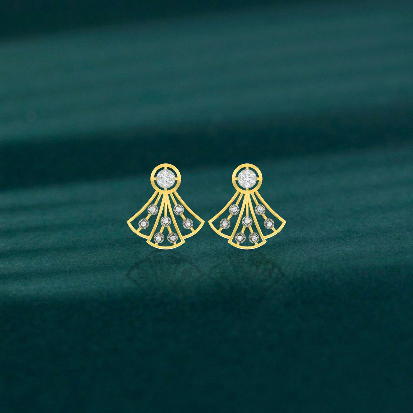 Gold and diamond dangler earrings on a teal background.