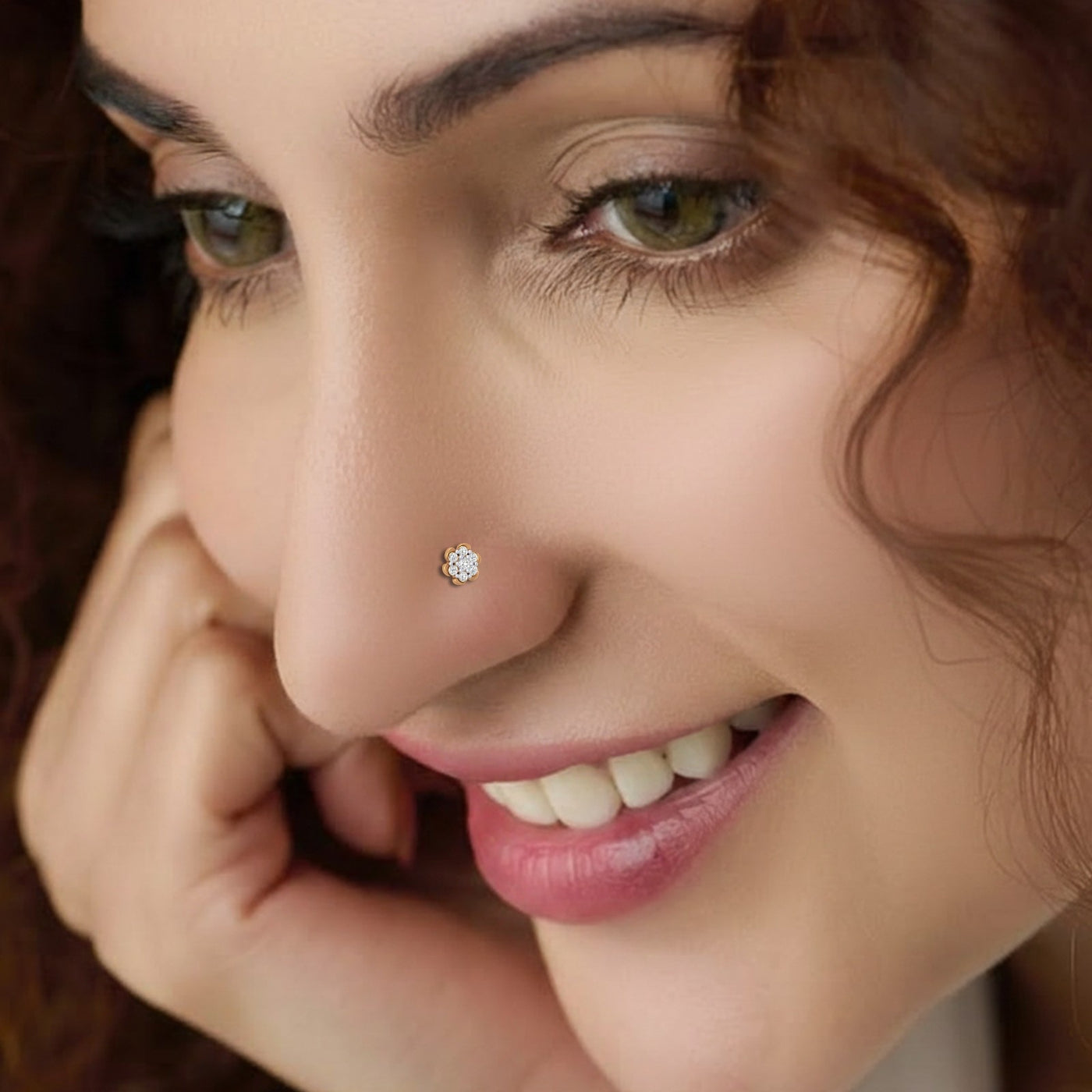 Close-up of a woman's face with a diamond nose pin.