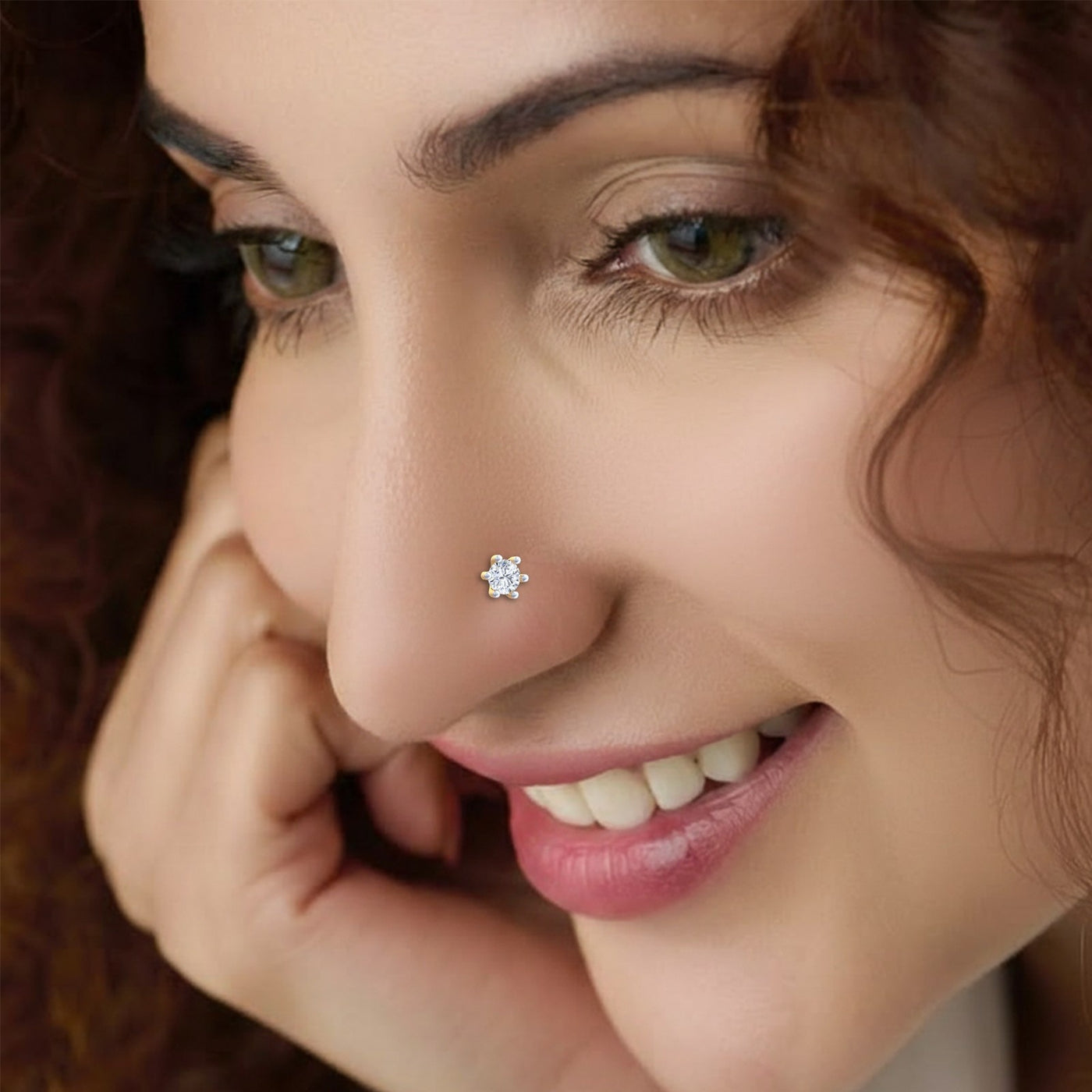 Close-up of a woman wearing a diamond nose pin with a blurred background