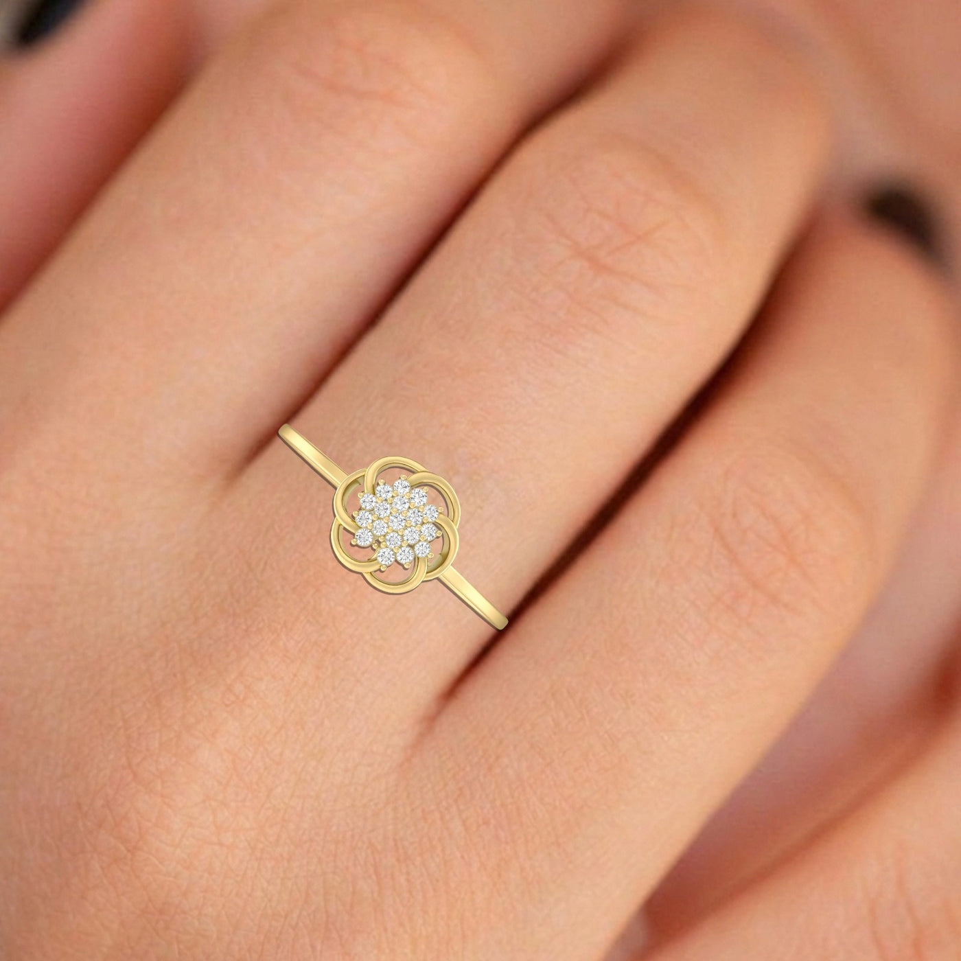 Gold ring with a diamond design on a finger