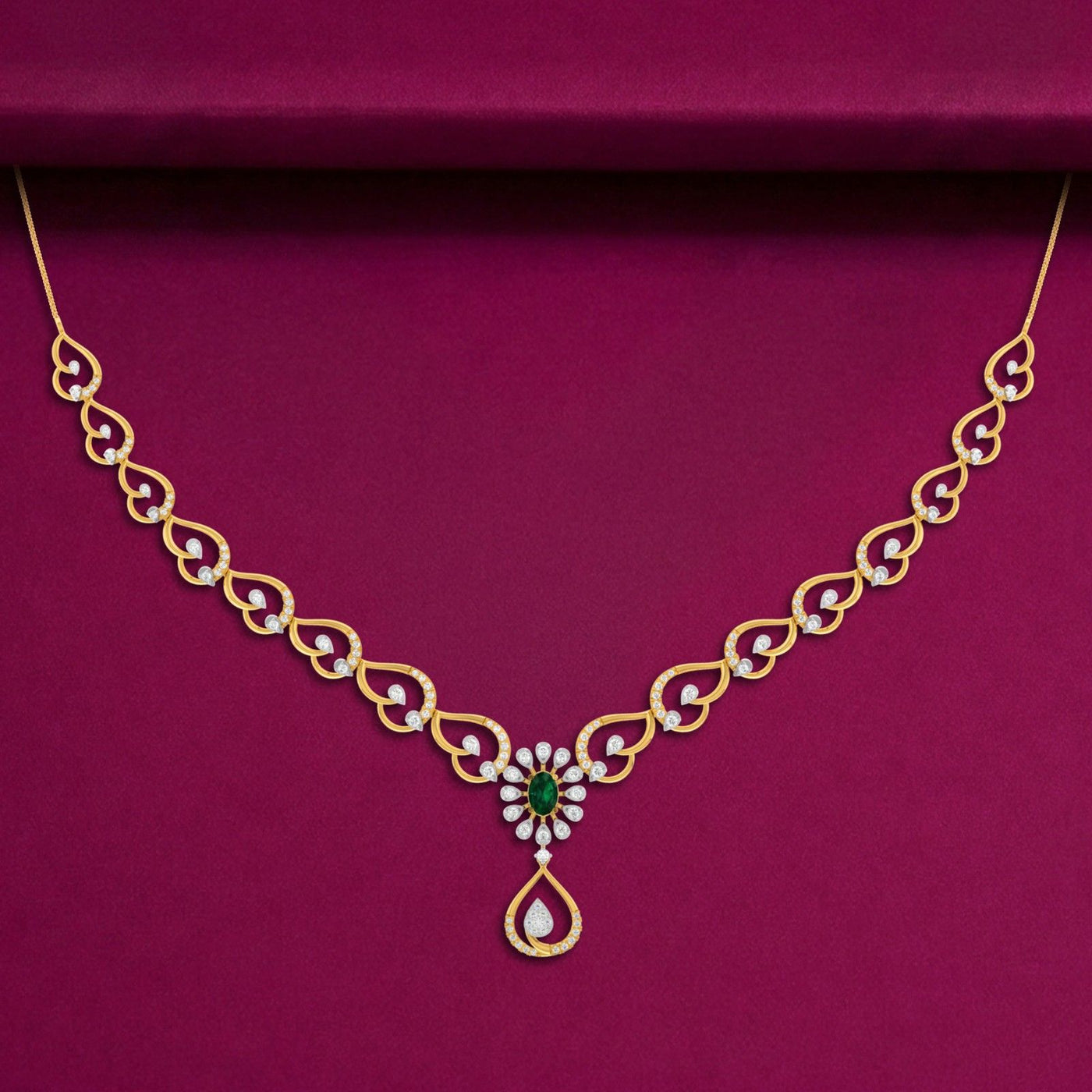 A gold and diamond necklace with a floral pendant, set against a deep magenta velvet background.