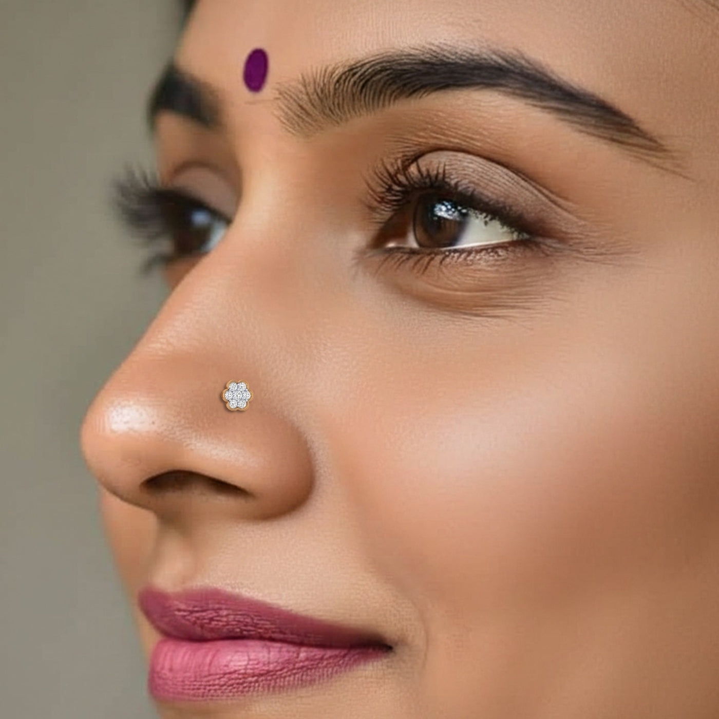 Close-up of a woman's face with a focus on her nose pin.