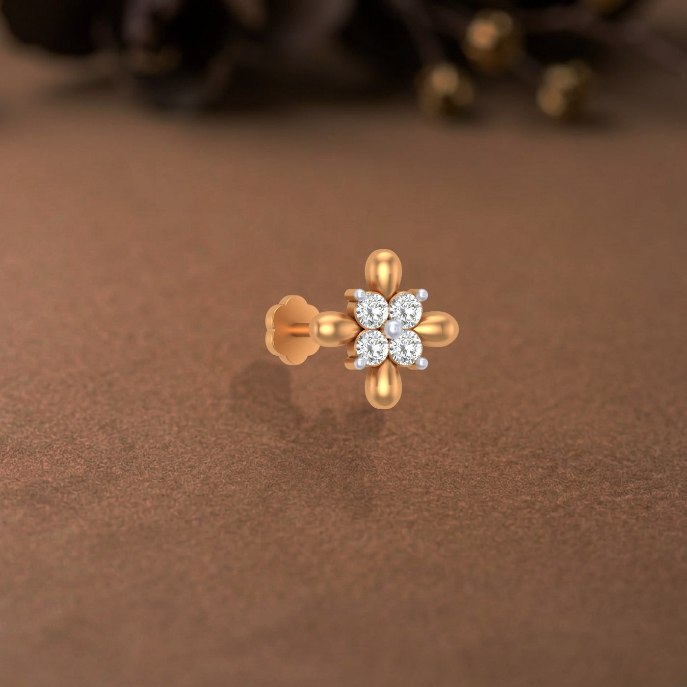 yellow gold and diamond stud nose pin-like stones on a brown surface