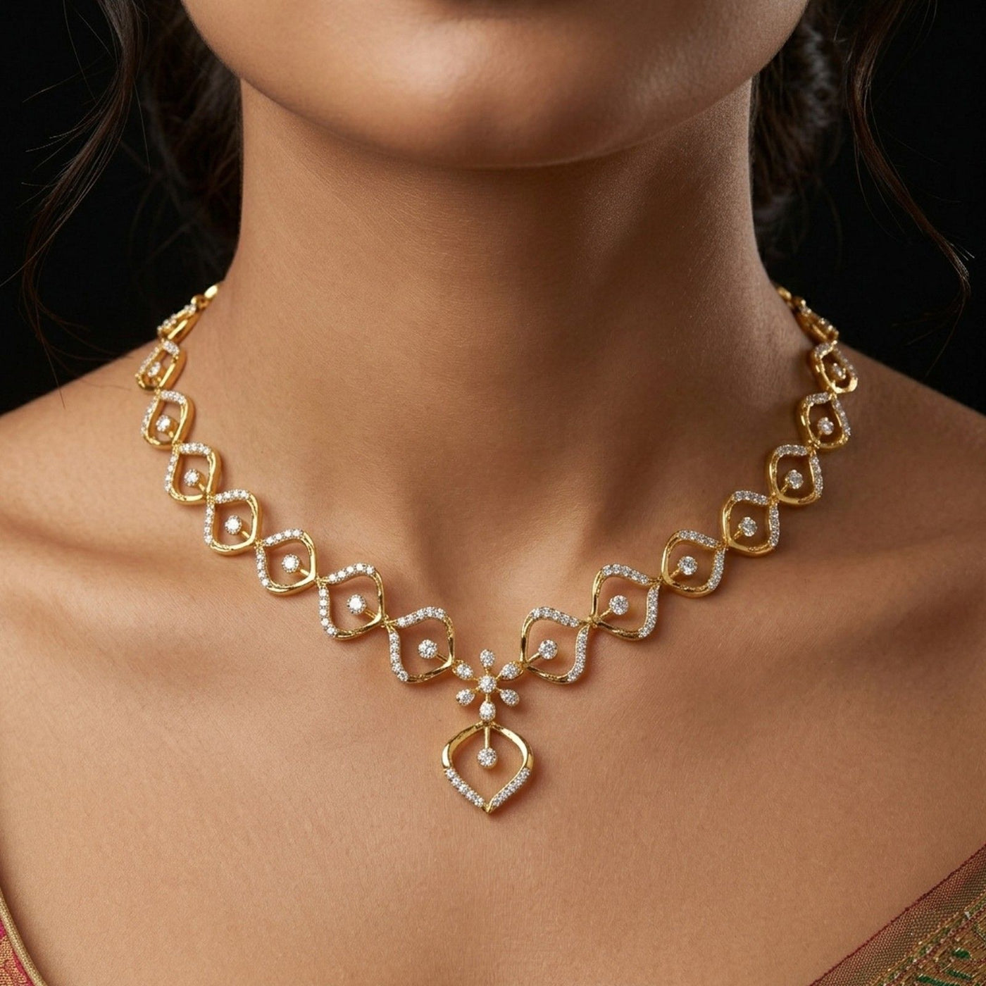 Gold necklace with diamond accents on a model against a dark background.
