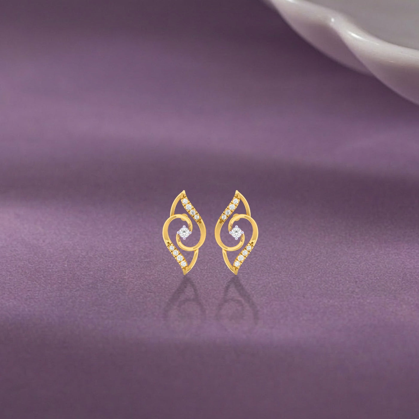 Gold and diamond stud earring  on a purple background.