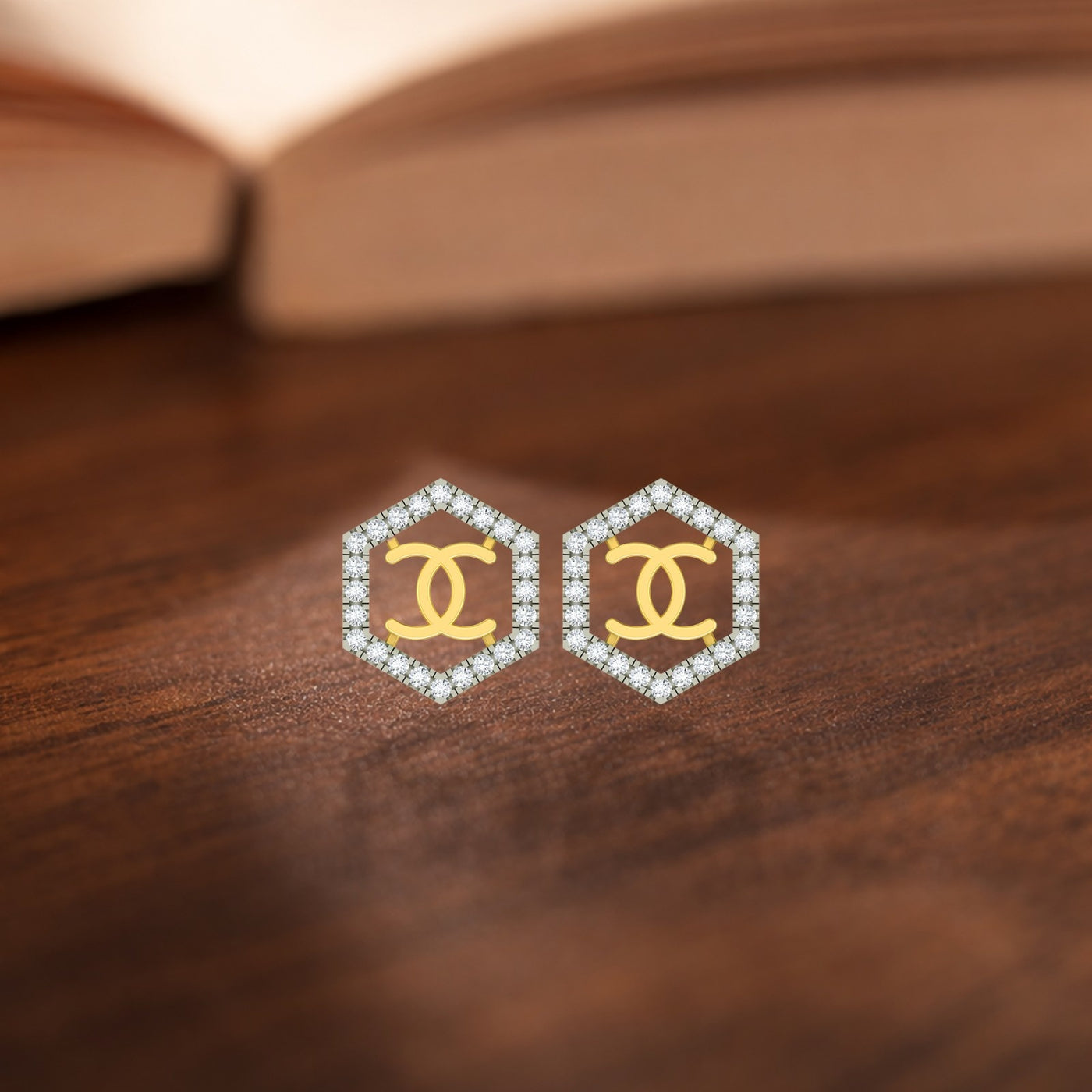 Gold and diamond stud earring with hexagonal-shaped on a wooden surface.