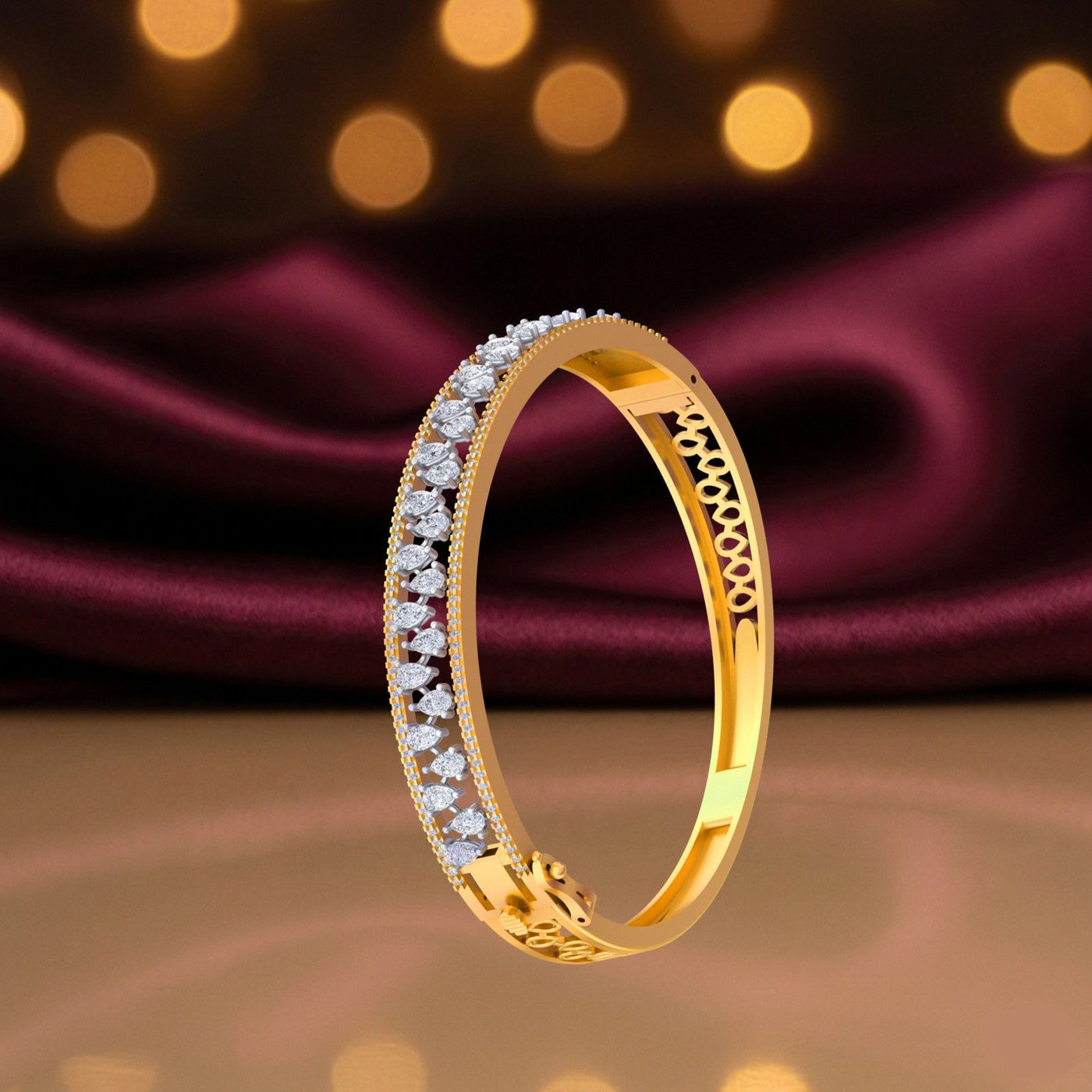 Gold bangle bracelet with marquise diamond row, pavé border and decorative filigree inner band.