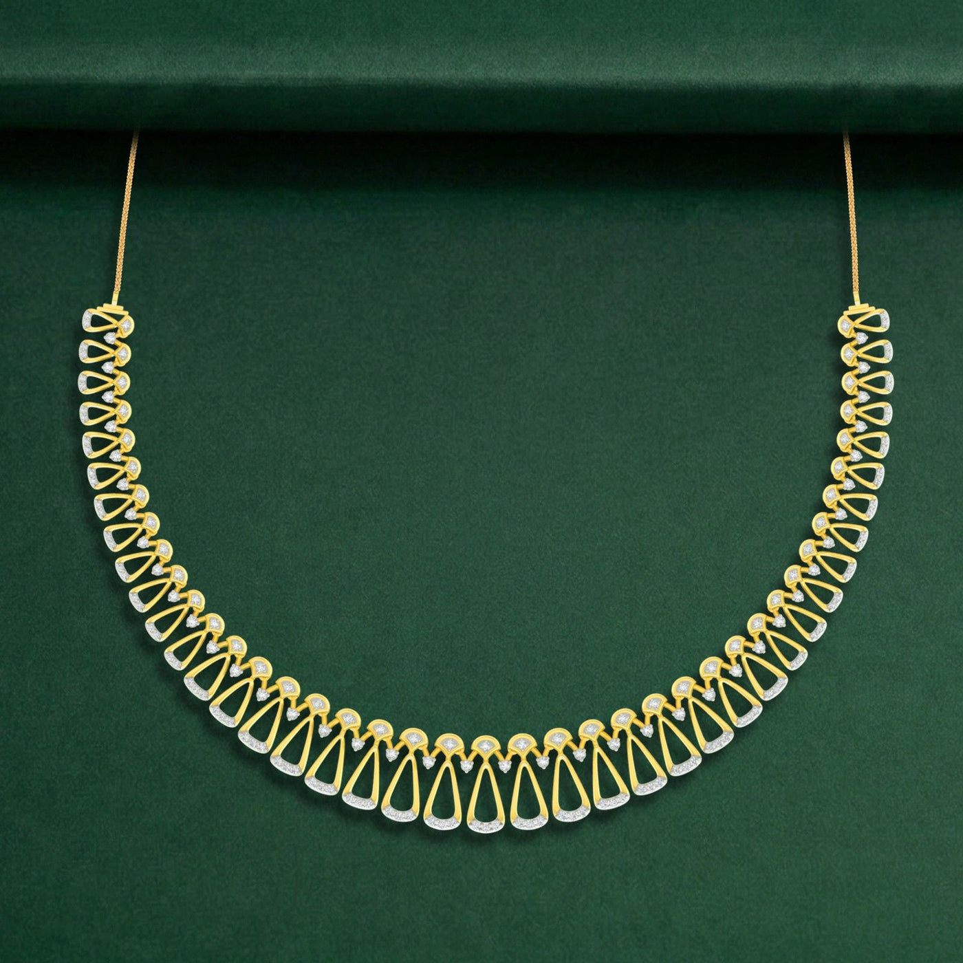 A gold and diamond necklace with a geometric pattern, displayed against a dark green background.
