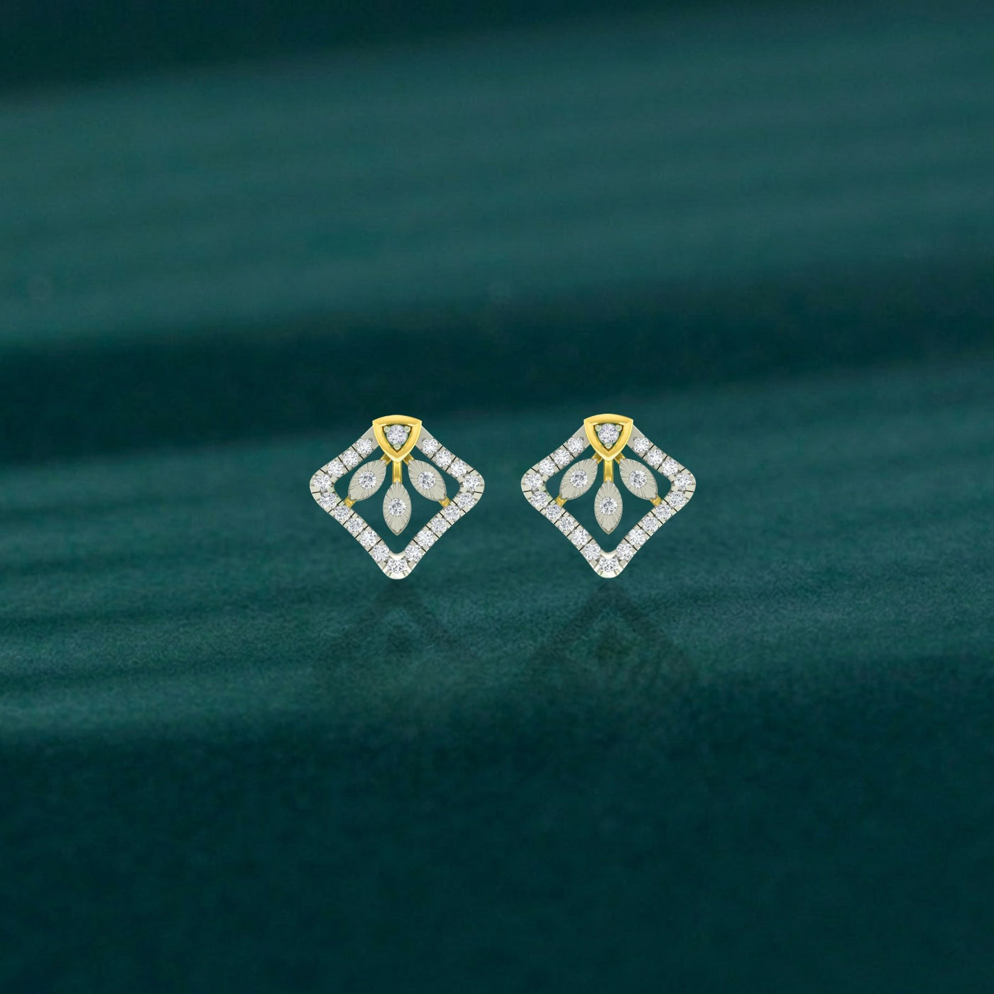 Pair of diamond earrings with gold and diamond design on a teal background.