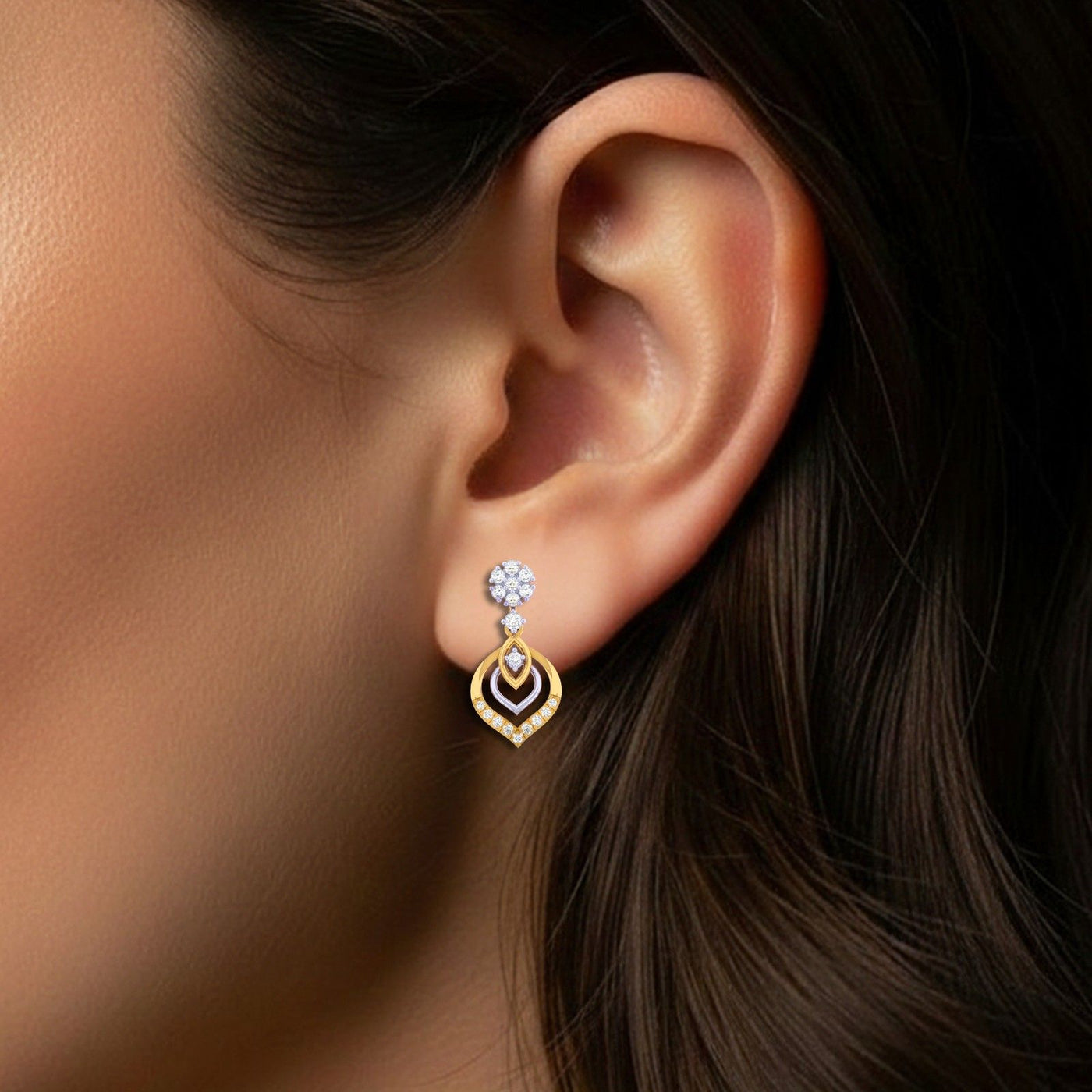 Close-up shot of a gold and diamond drop earring.