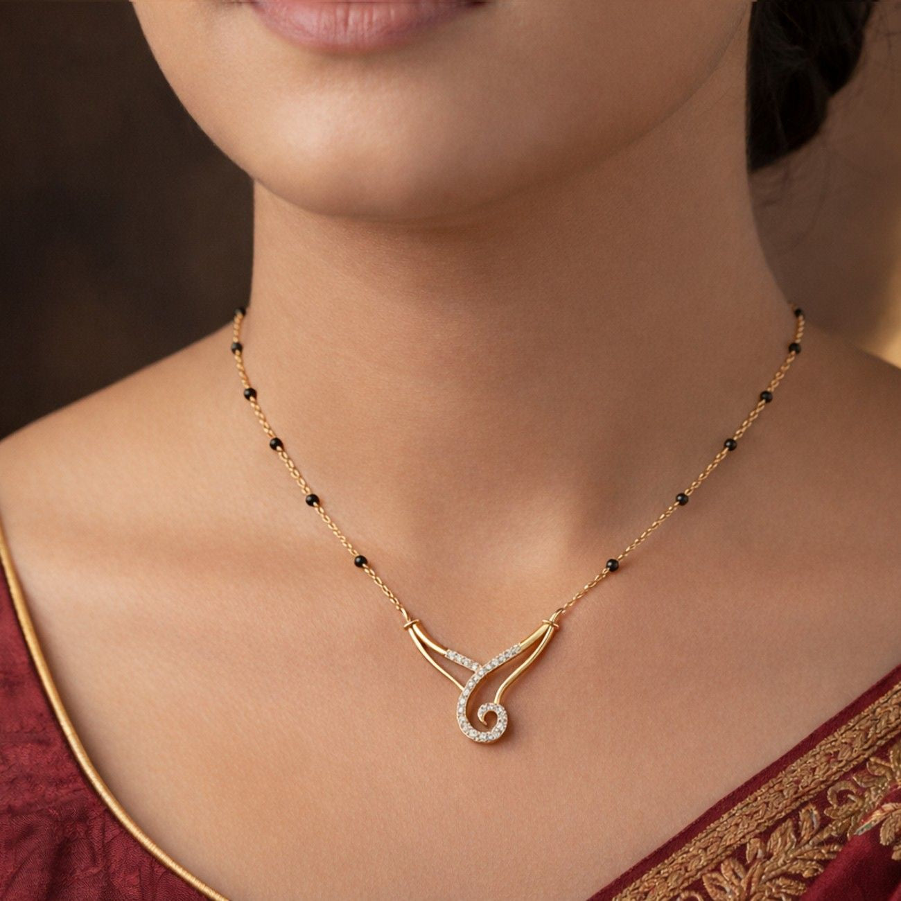 Women wearing yellow gold & diamond modern mangalsutra