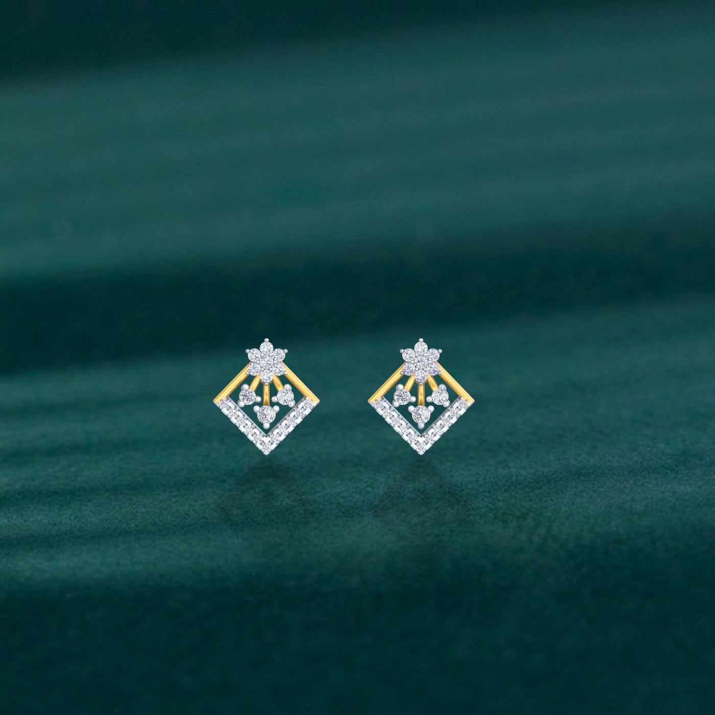 Gold and diamond stud earrings on a teal background.