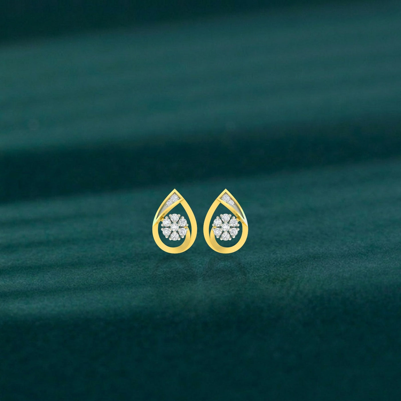 Gold and diamond stud earring with teardrop-design on a teal background